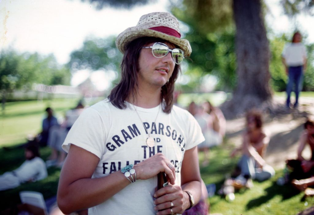LOS ANGELES - JUNE 1973: Singer/songwriter Gram Parsons wears a Gram Parsons and the Fallen Angels T-shirt at a party in the park in June 1973 in Los Angeles, California. (Photo by Ginny Winn/Michael Ochs Archives/Getty Images)