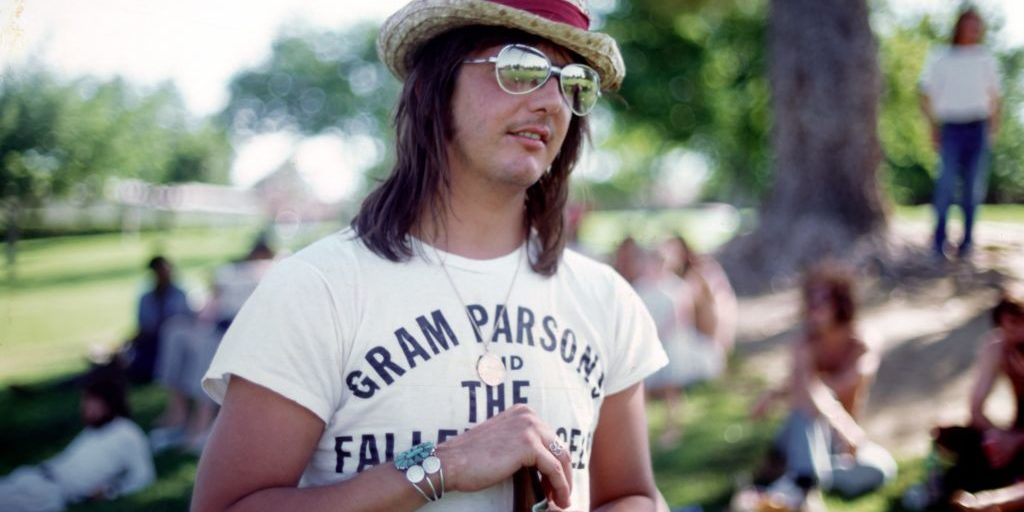 LOS ANGELES - JUNE 1973: Singer/songwriter Gram Parsons wears a Gram Parsons and the Fallen Angels T-shirt at a party in the park in June 1973 in Los Angeles, California. (Photo by Ginny Winn/Michael Ochs Archives/Getty Images)