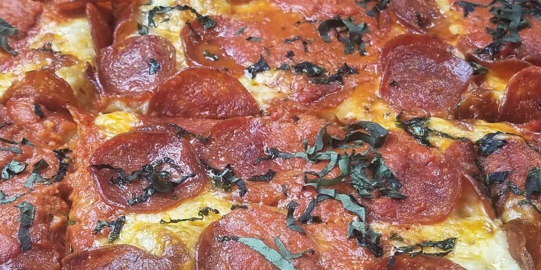 NOLA Pizza Co. has a process that has made them a popular addition to the local pizza scene. They have 10 pizza offerings on their menu. This is the #10: a square pie with vodka sauce, pepperoni and basil.