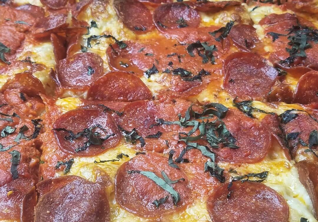 NOLA Pizza Co. has a process that has made them a popular addition to the local pizza scene. They have 10 pizza offerings on their menu. This is the #10: a square pie with vodka sauce, pepperoni and basil.