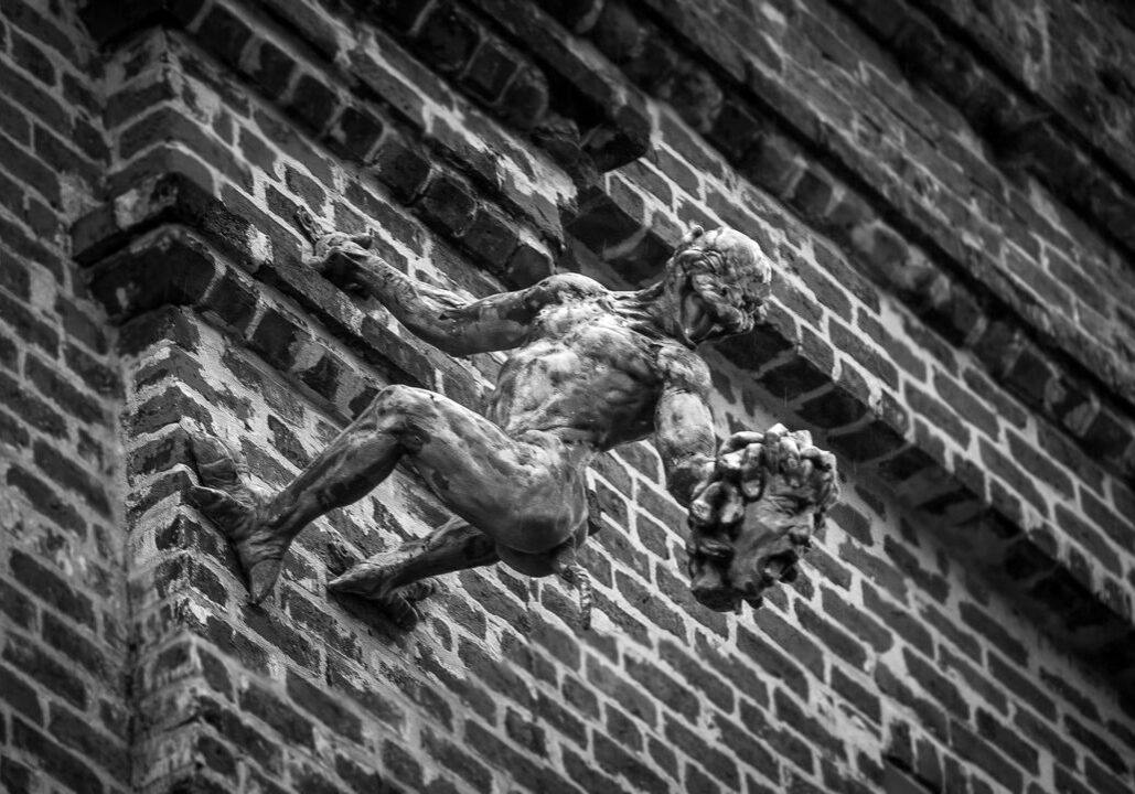A devilish figures holds a severed head on the side of a Jackson Avenue building not far from the original site of the Devil’s Mansion. (Photo by Michael DeMocker)