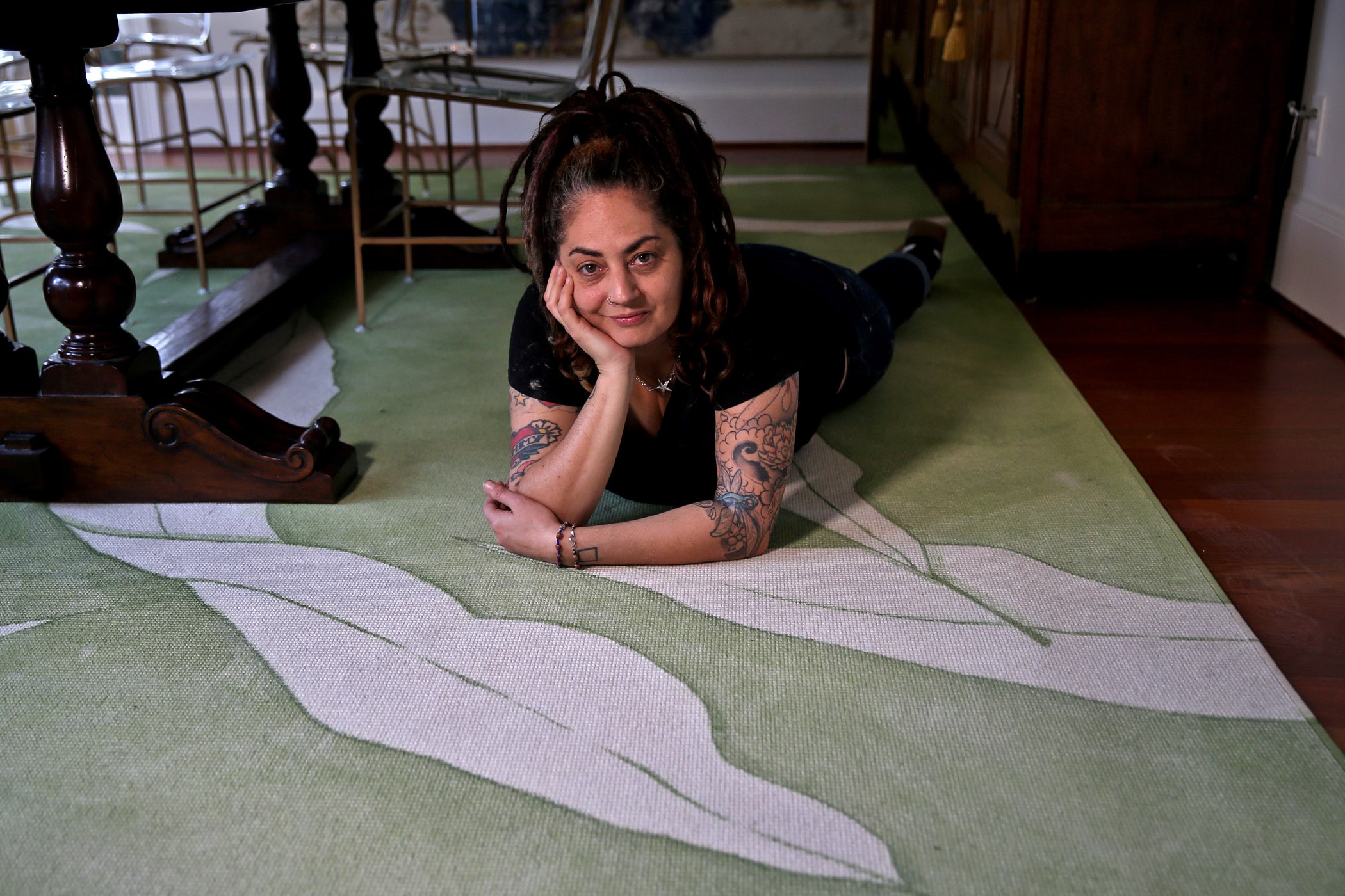 Artist Ann Marie Auricchio with a rug she designed in an Old Metairie home on Friday, November 22, 2019. (Photo by Michael DeMocker)