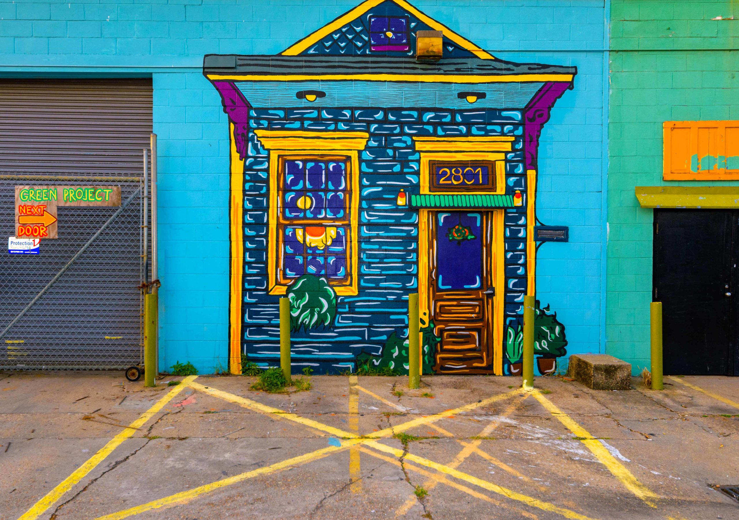 PaintedPortals : A house appears on a wall with a door by the loading gates for the Green Project in the Bywater and St. Roch neighborhoods of New Orleans. The salvage store at the Green Project states it diverts 2 million pounds of used but usable building materials of all sorts including the kitchen sink. The store is open Thursday-Saturday during the pandemic. Photo by @MattHintonPhoto for @VeryLocalNOLA
.
.
.
#Recycling @thegreenproject #NewOrleans #Louisiana #VLNOLA #vintage #antiques #doors #painteddoor