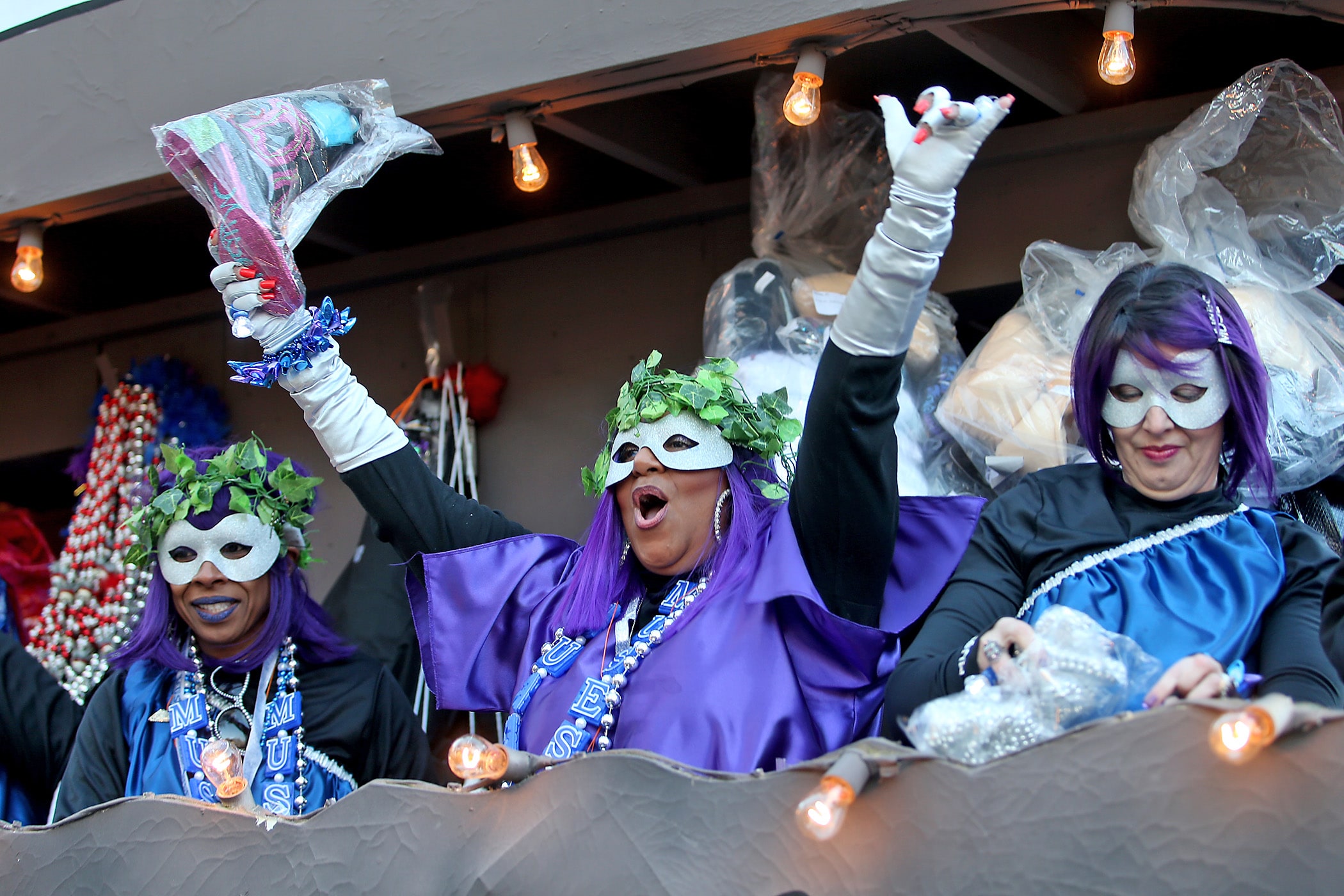 A rider offers up a shoe as the over 1100 women of the Krewe of Muses roll down the Uptown parade route with a 26-float parade with the theme “Nostradamuse Sees All” as they celebrate their 20th anniversary on Friday, February 21, 2020. (Photo by Michael DeMocker)
