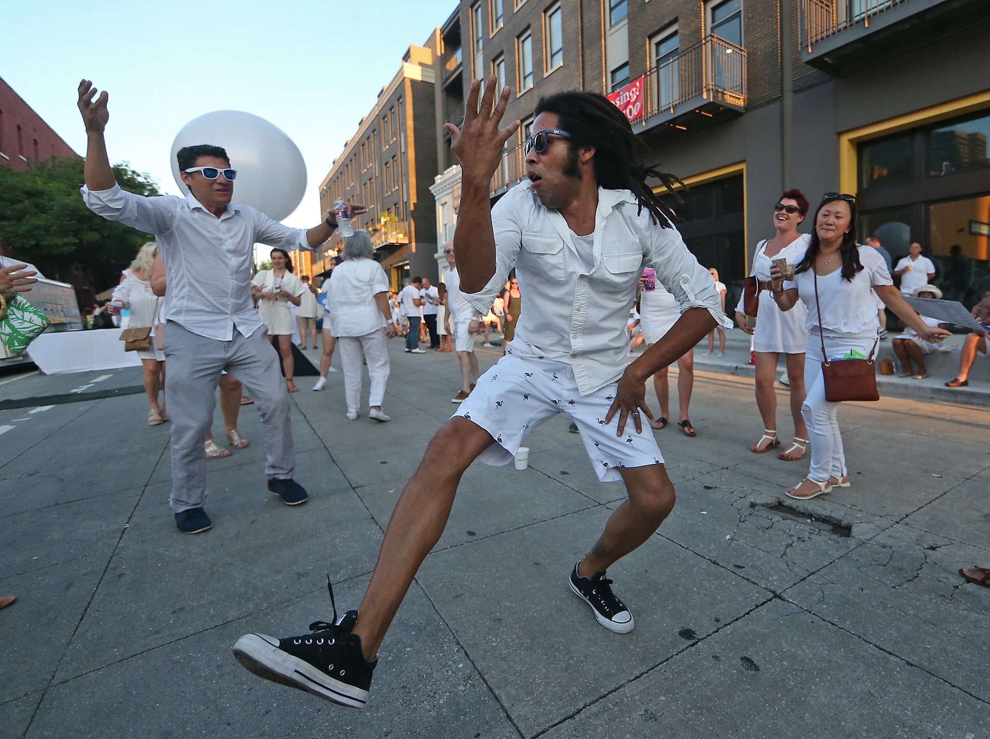 Brien Teasley dances in front of the stage in the 700 block of Julia Street during the 25th annual Hancock Whitney White Linen Night in the 300 to 700 blocks of Julia Street as well as other venues around the Arts District New Orleans. The free block party featured live music, food and drink from over thirty local vendors, gallery openings, and displays of public art, all benefiting the Contemporary Arts Center.