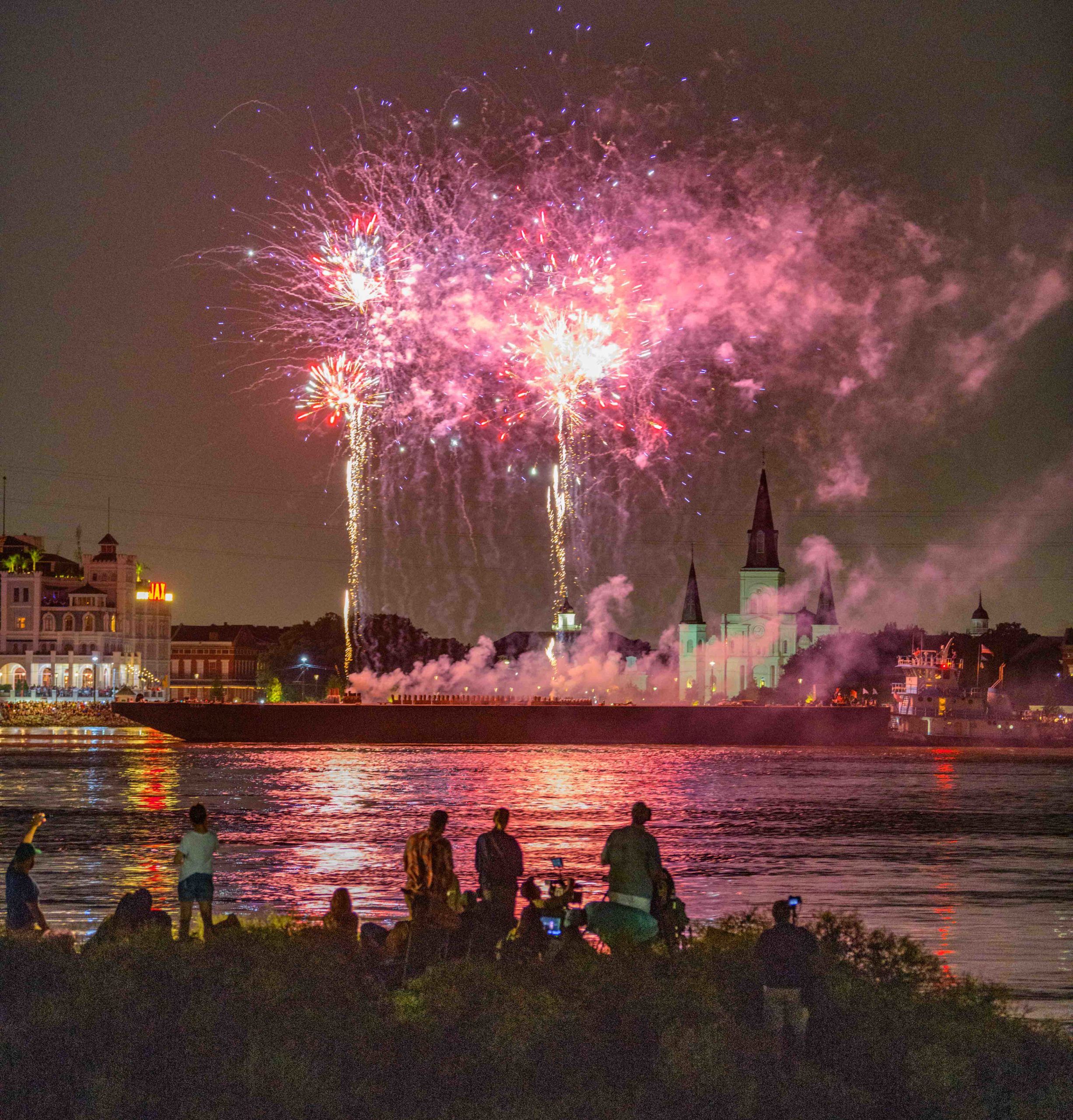 Fireworks are launched from a barge in front of St. Louis Cathedral in the French Quarter as seen from the Algiers Point river levee during the annual Go Fourth on the River in New Orleans, La. Thursday, July 4, 2019 to celebrate Independence Day. Normally two barges are set up for the fireworks display but the high river and strong currents resulted in a single barge this year. The Bonnet Carre Spillway up river is currently open to relieve the possibility of flooding in New Orleans and has been opened twice this year for the first time in history because of the prolonged risk of flooding. Photo by Matthew Hinton