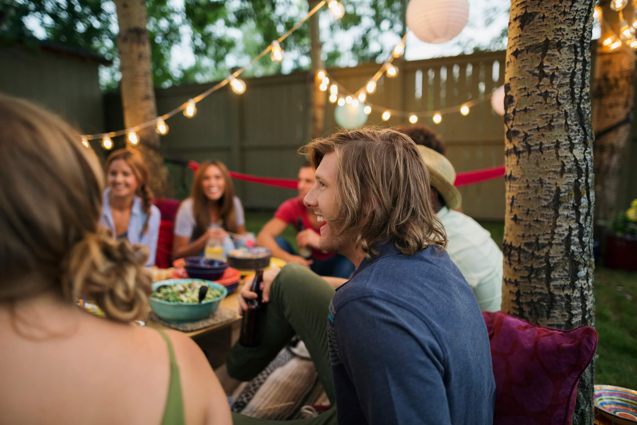 Friends enjoying backyard dinner party