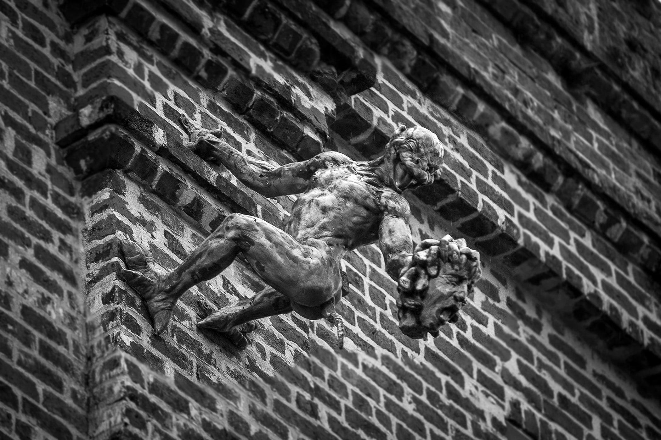 A devilish figures holds a severed head on the side of a Jackson Avenue building not far from the original site of the Devil’s Mansion. (Photo by Michael DeMocker)