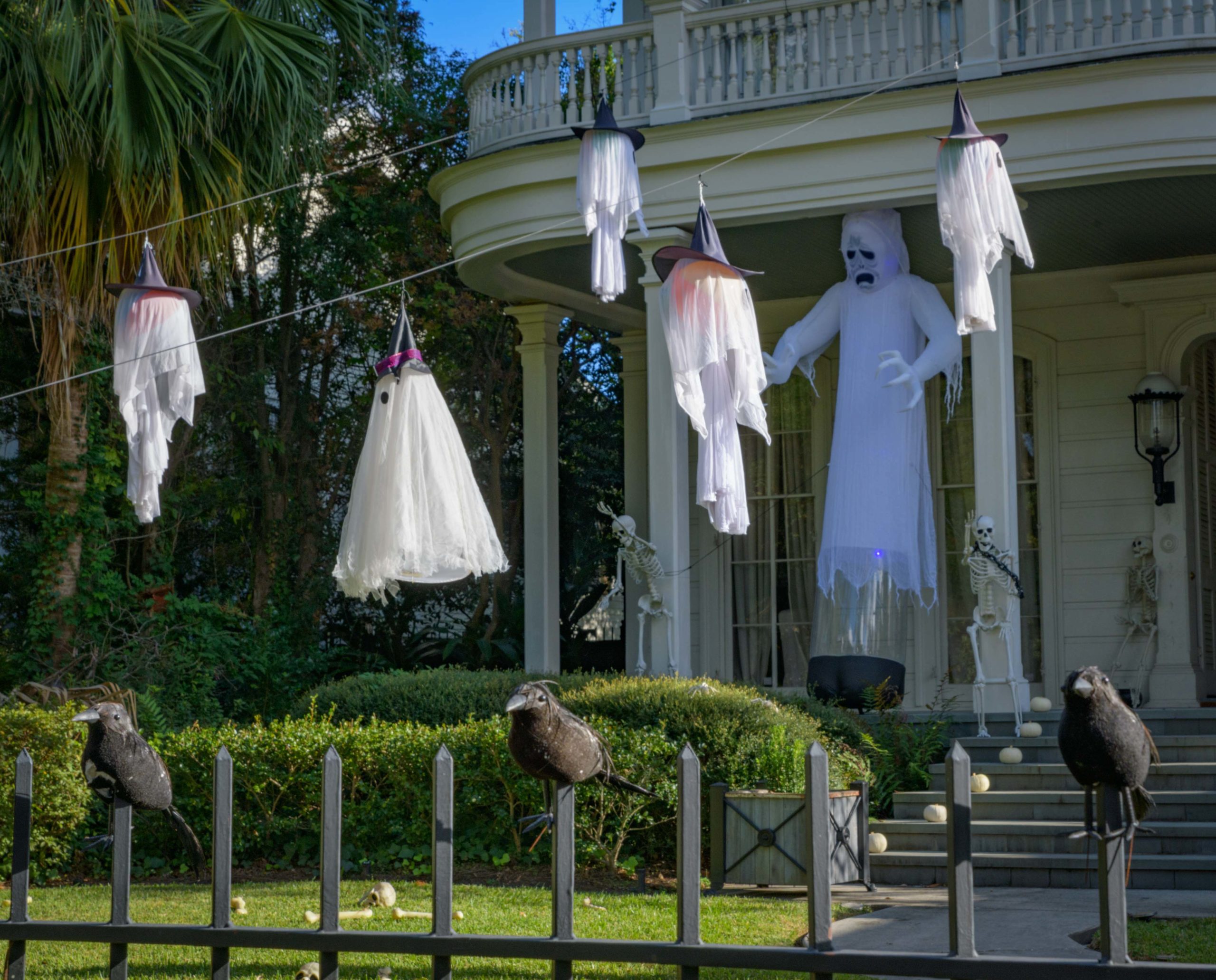 A home on St. Charles Ave. has many ghosts taking flight while crows hang out on the fence. Photo by Matthew Hinton