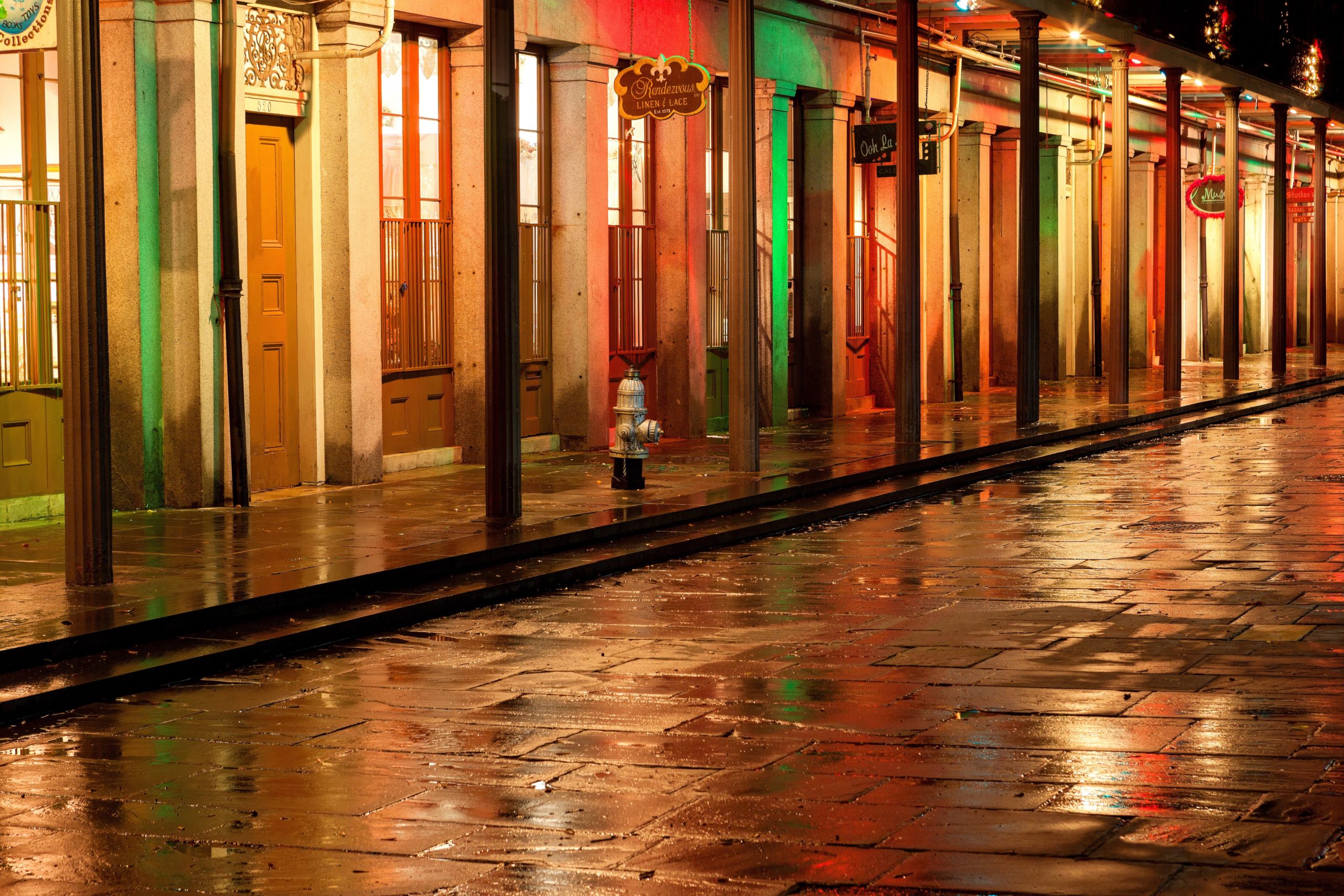 Reflections of holiday lights at night after a brief rainstorm, New Orleans French Quarter.