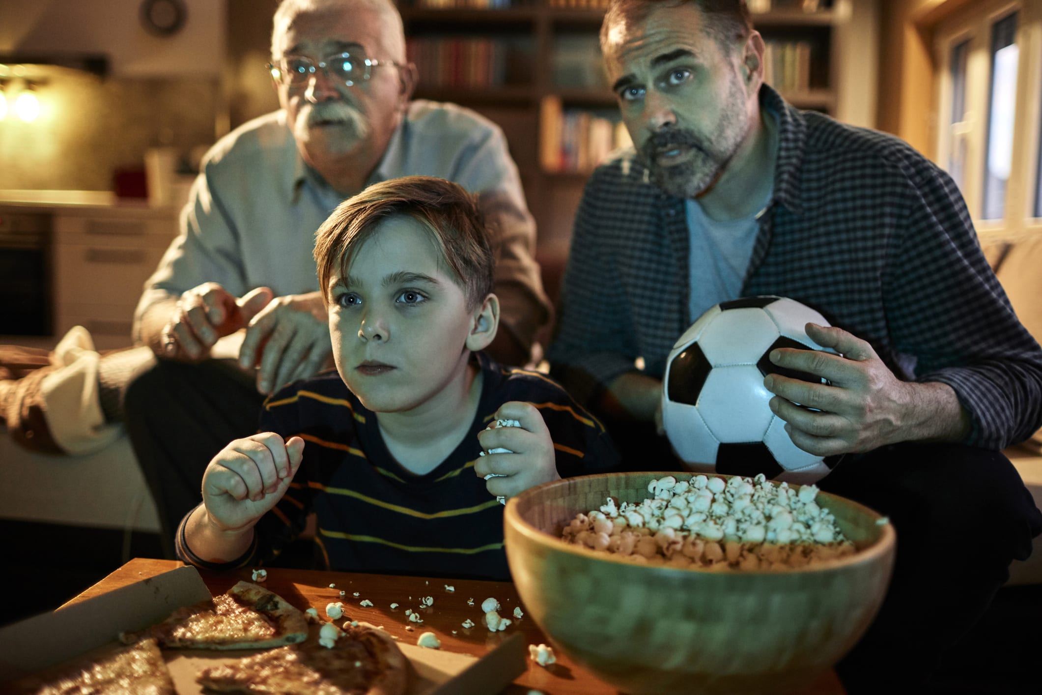 Close up of a family watching and cheering for their team