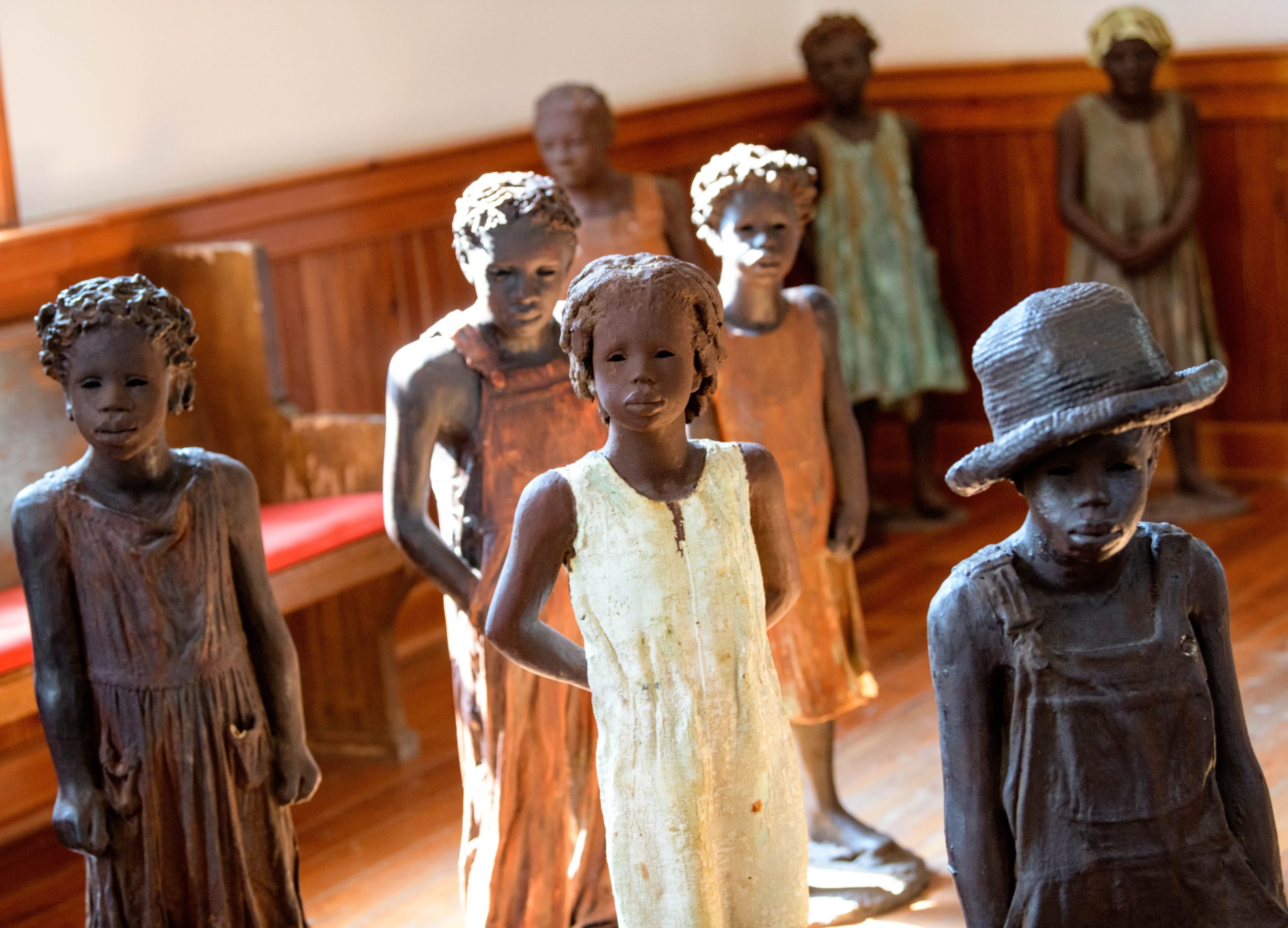 Terra-cotta statues of child slaves created by artist Woodrow Nash are seen inside of a church at the Whitney Plantation in  Wallace, La. in St. John Parish Wednesday, Oct. 2, 2019. When the WPA, Works Progress Administration, began interviewing former slaves in the 1930s in Louisiana most talked about their experience as children during slavery. Photo by Matthew Hinton