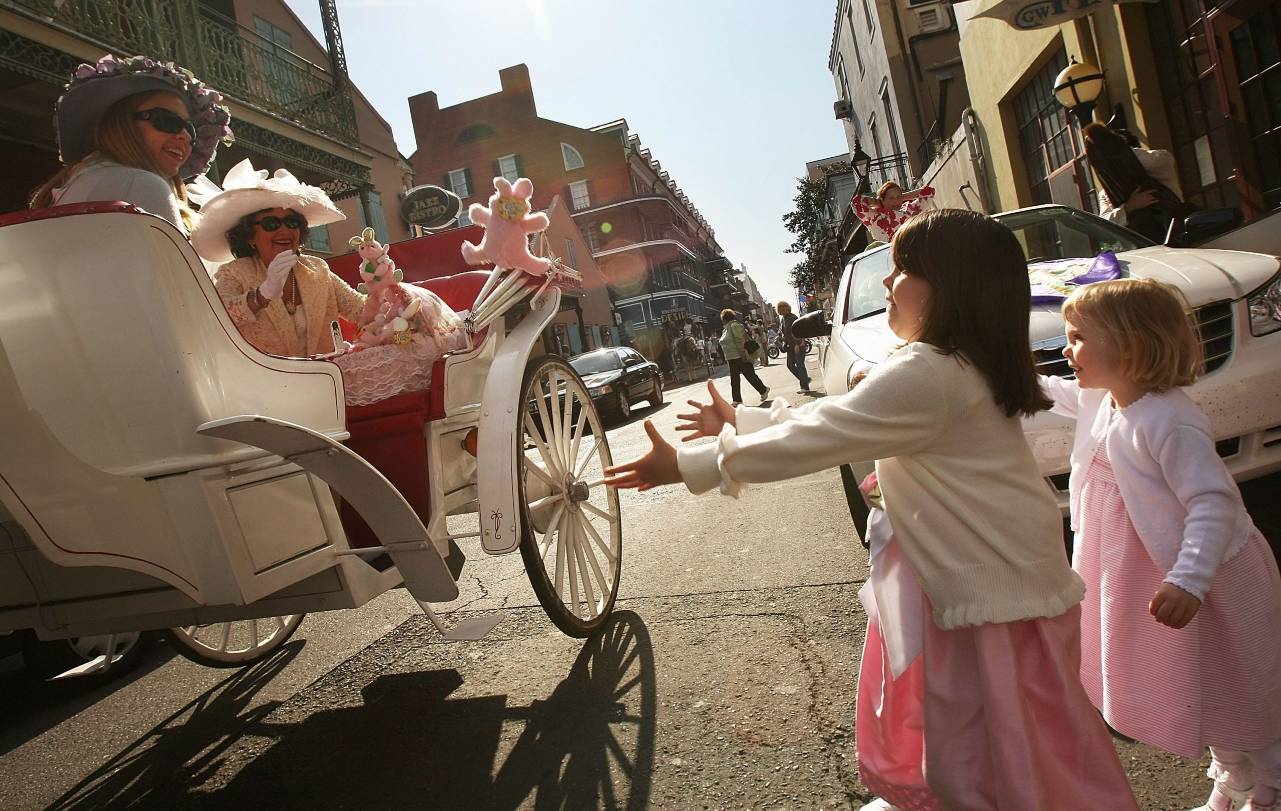 NEW ORLEANS - MARCH 23:  Josie (R) and Ashlee Arena wait to catch an Easter bunny during the Historic French Quarter Easter Parade March 23, 2008 in New Orleans, Louisiana. Christians worldwide are celebrating Easter on the final day of Holy Week.  (Photo by Mario Tama/Getty Images)