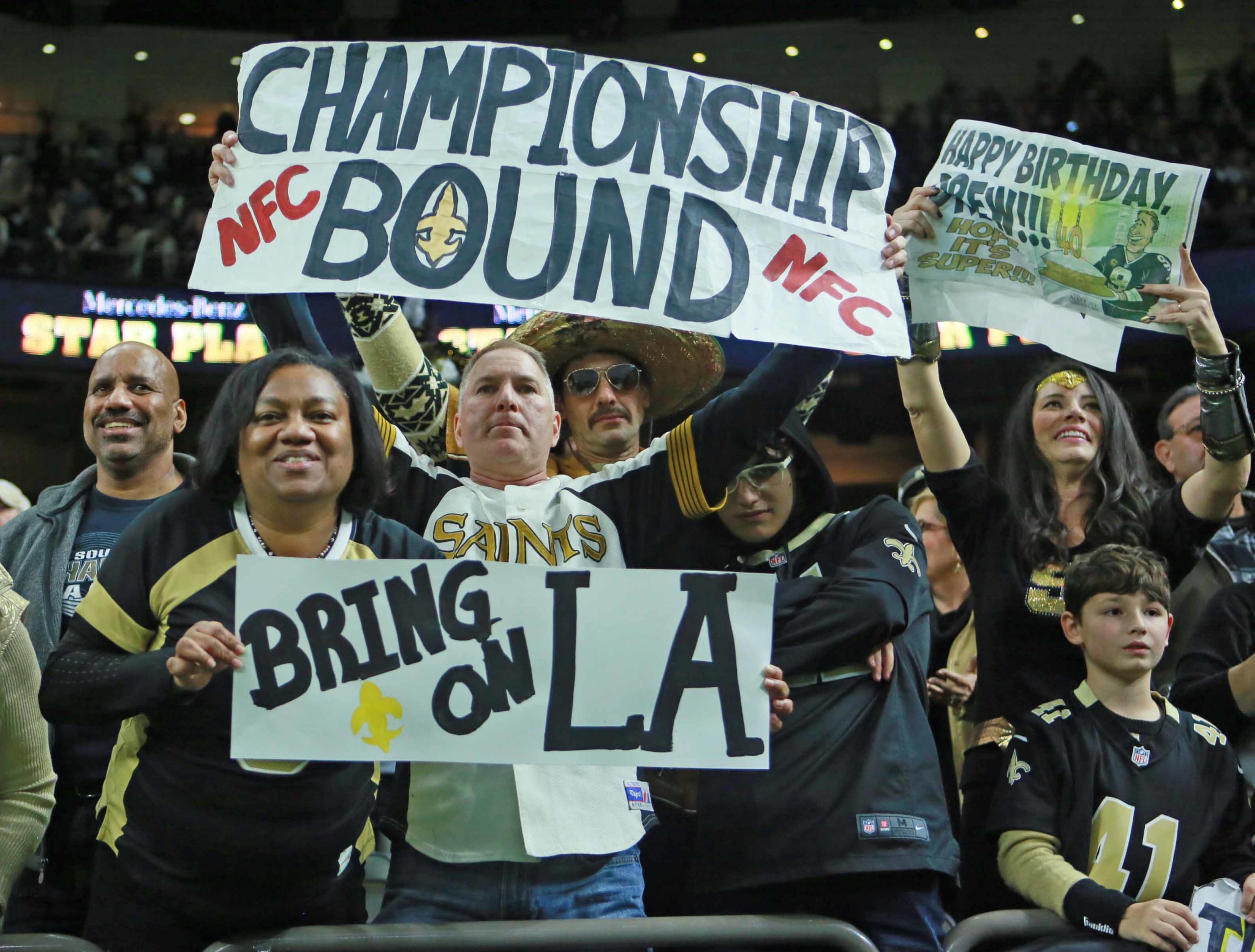 New Orleans Saints superfan Larry Rolling (top) holds up the NFC Championship bound sign at the conclusion of the NFC Divisional Playoffs at the Mercedes-Benz Superdome in New Orleans on Sunday, January 13, 2019.  (Photo by Peter G. Forest / Very Local New Orleans)