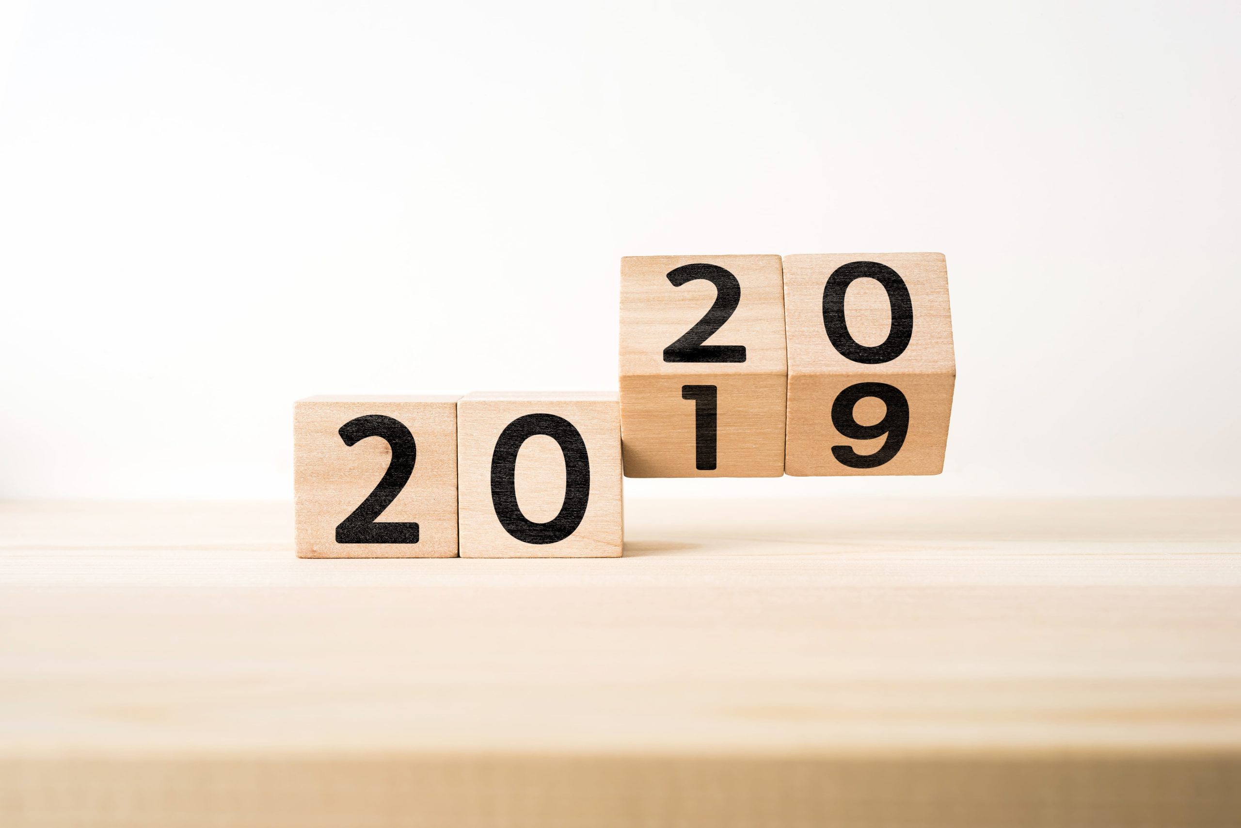 Close-Up Of Wooden Blocks With 2019 2020 Number On Table Against White Background