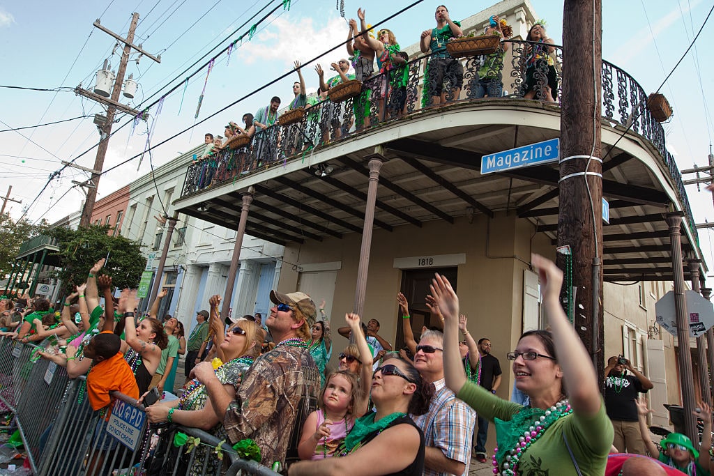 March 17, 2012 , New Orleans, Louisiana, People line Magazine Street at the Irish flag at The Irish Channel St. Patrick's Day Parade. Cabbages, toys and beads are thrown of floats as they drive by. Fodor's ranks New Orleans as the second best place to celebrate St. Patrick's Day in America. (Photo by Julie Dermansky/Corbis via Getty Images)