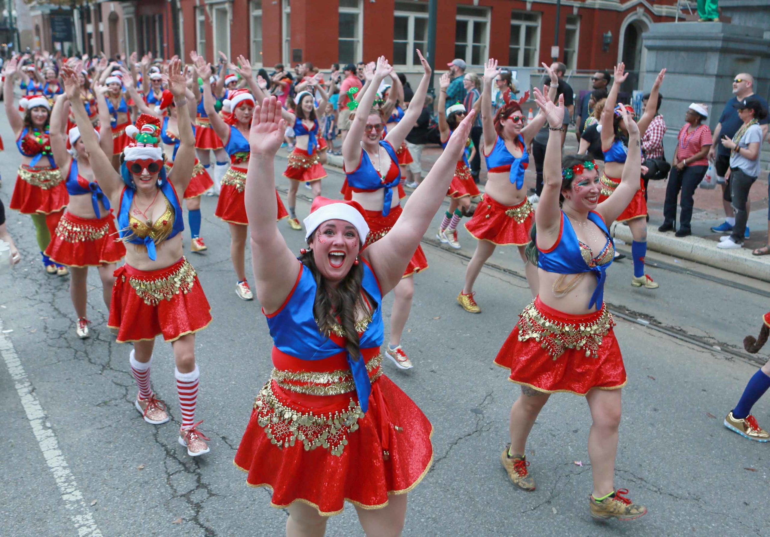 A dance krewe makes perform during the Krewe of Jingle Parade as it passes through St. Charles Avenue in New Orleans on Saturday, December 1, 2018.  (Photo by Peter G. Forest)