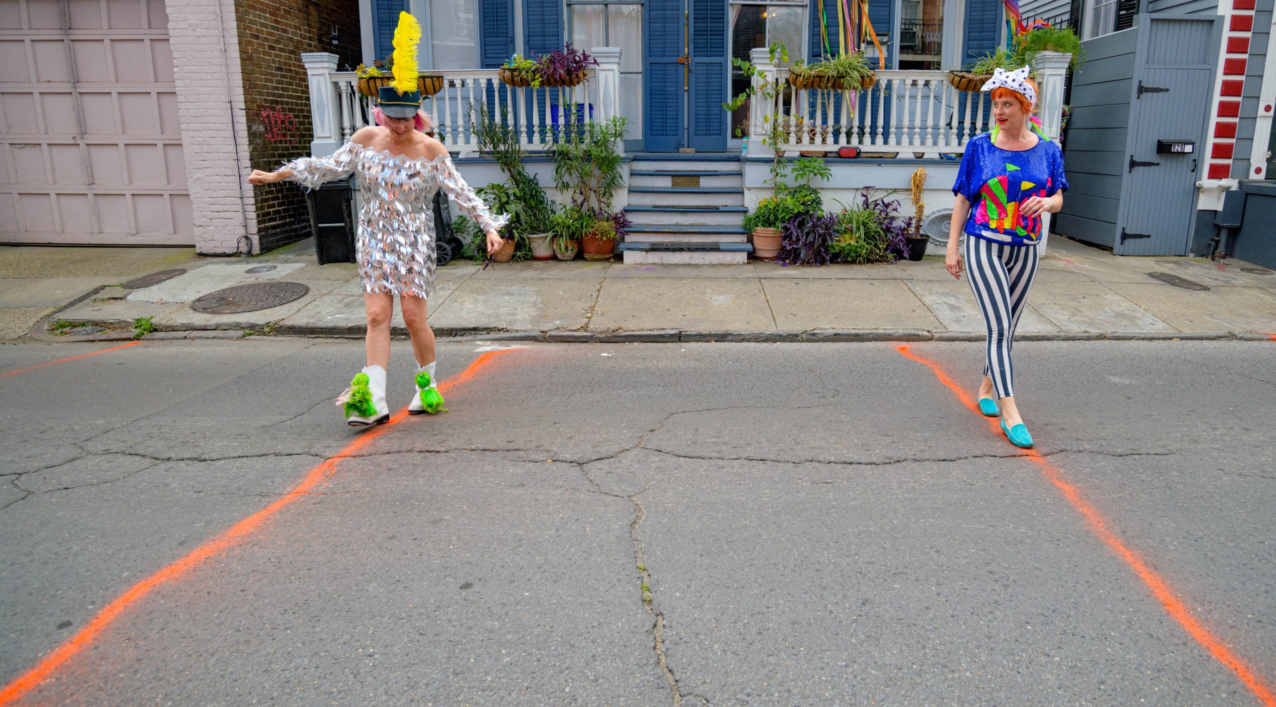 The Traveler Broads, Kerry Maloney, left, and Jessica Fender, line dance ten-feet apart to keep a safe distance during the COVID-19 pandemic near their home in New Orleans, St. Josephs Day, Thursday, March 19, 2020. Photo by Matthew Hinton
