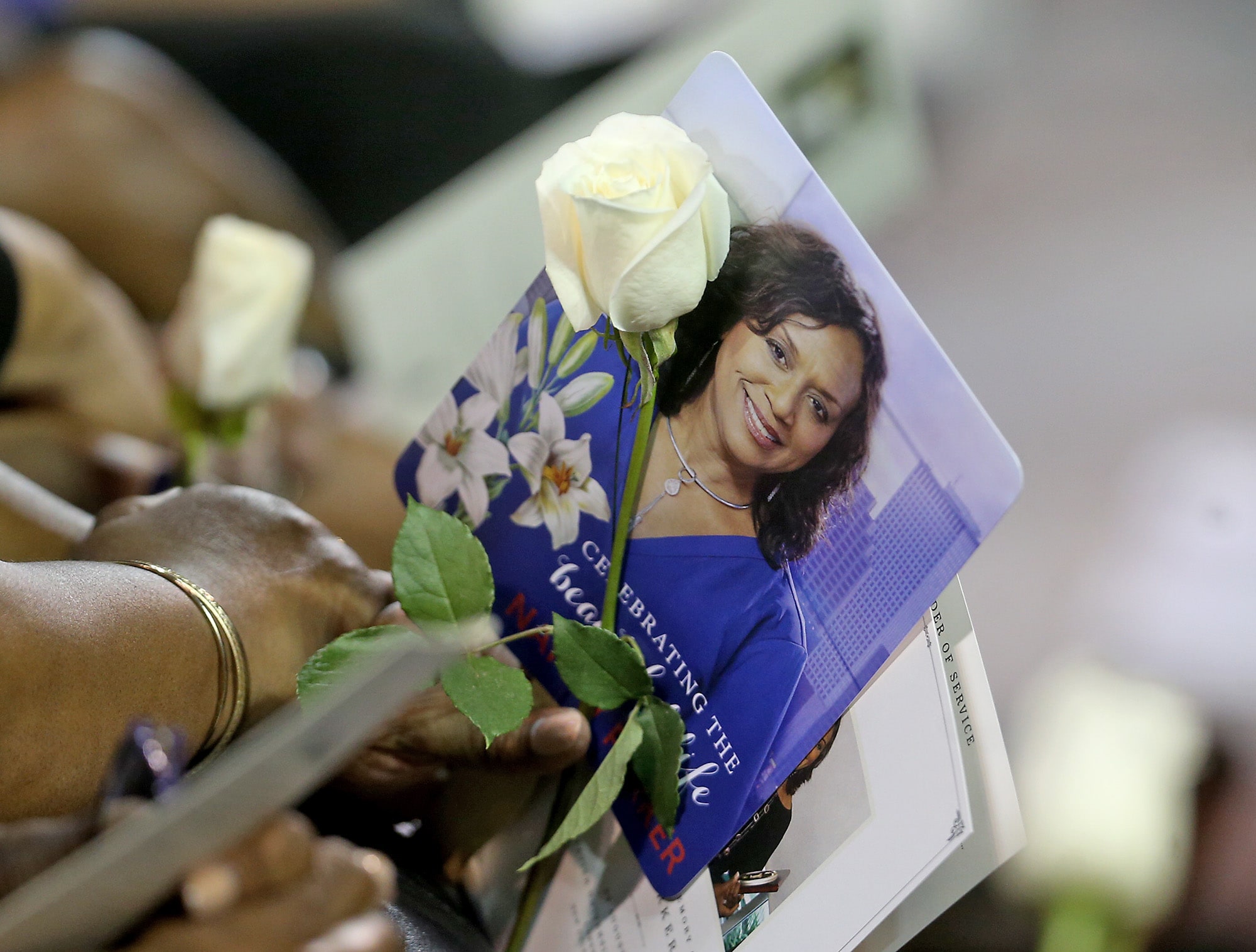 Flowers and photos during the public memorial service at the Xavier Convocation Center for Fox 8 journalist and anchor Nancy Parker who was killed last week in a small plane crash while working on a story. (Photo by Michael DeMocker)
