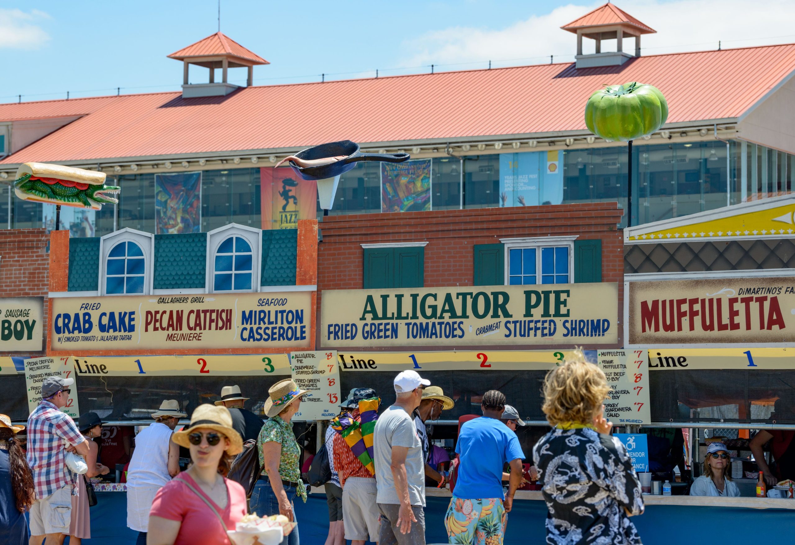 People enjoy food during the 50th New Orleans Jazz and Heritage Festival at the Fair Grounds in New Orleans, La. Sunday, April 28, 2019. Photo by Matthew Hinton