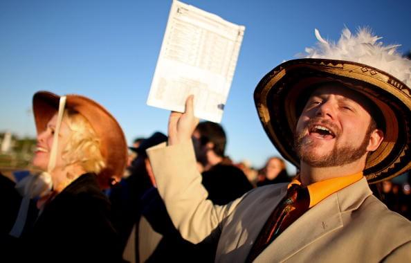 NEW ORLEANS - NOVEMBER 26:  Fans cheer during the Thanksgiving Day horse races at the Fair Grounds Race Track November 26, 2009 in New Orleans, Louisiana. Each year people don their Thanksgiving finest and watch the races in an old New Orleans tradition.  (Photo by Mario Tama/Getty Images)