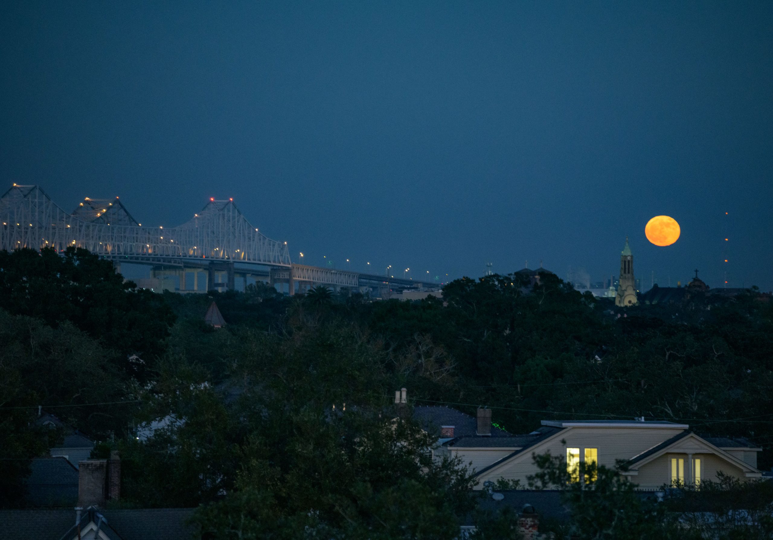 Once in a Blue Moon the full moon rises on Halloween over St. Marys Assumption Church of St. Alphonsus Parish by the Crescent City Connection in New Orleans, Saturday, Oct. 31, 2020. 
Photo by Matthew Hinton