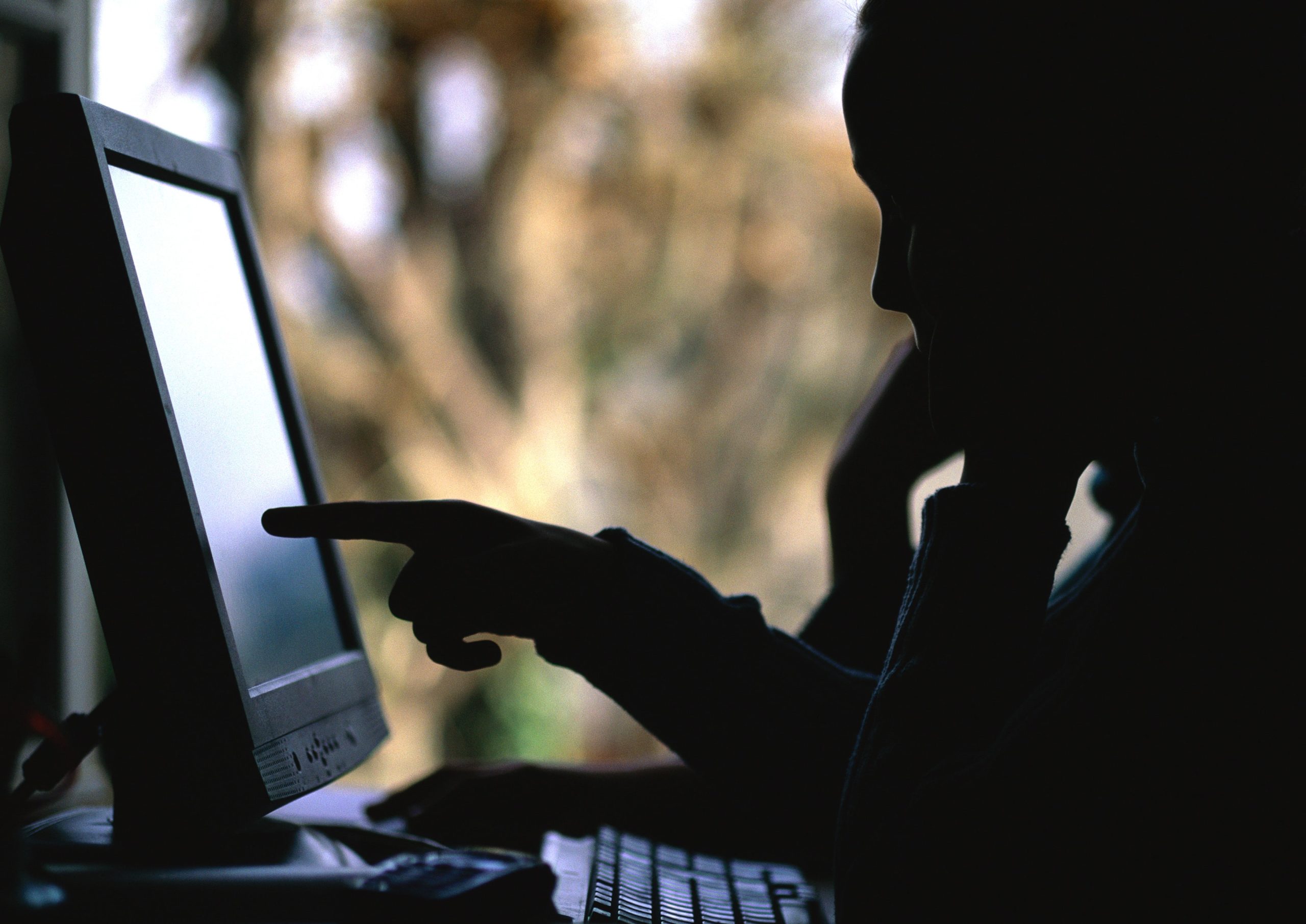 Child in front of computer, silhouette.