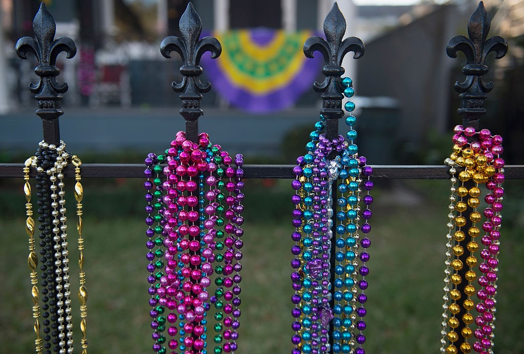 NEW ORLEANS, LA - FEBRUARY 07: Mardi Gras beads adorn a fleur de lis iron fence along the Uptown parade route before the 2016  Krewe Of Bacchus parade on February 7, 2016 in New Orleans, Louisiana.  (Photo by Erika Goldring/Getty Images)