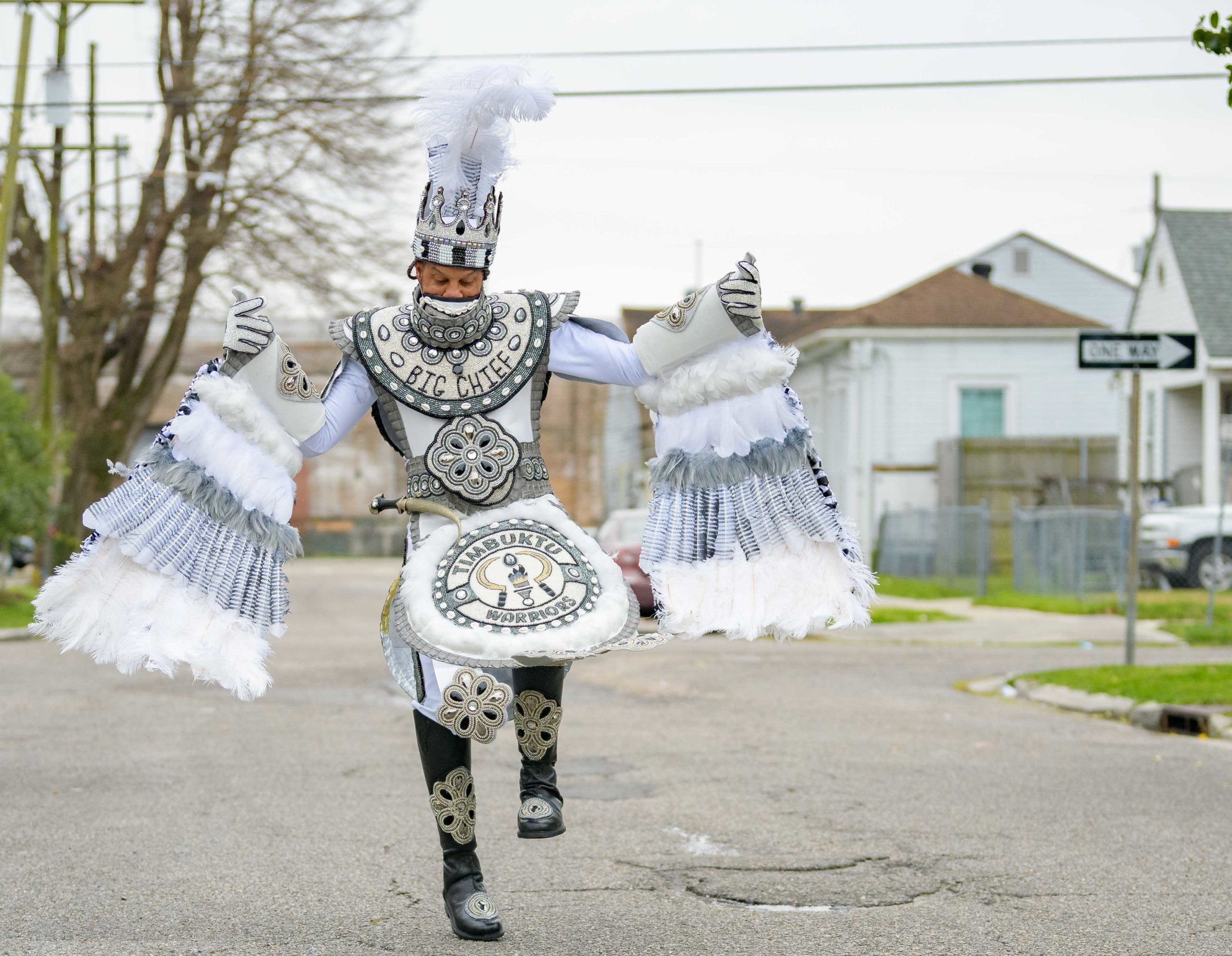 Early that mornin’ a house float came to life on Mardi Gras as Big Chief Dow Edwards of the Timbuktu Warriors paraded around the block of his home on Amelia Street in the Riverside neighborhood in New Orleans on Fat Tuesday, Feb 16, 2021. The weeks leading up to Mardi Gras Big Chief Dow displayed suits from his time as Spy Boy for the Mohawk Hunters as his house float. The Krewe of House Floats is an initiative to decorate homes during the Carnival season because of the cancellation and postponement of parades and gatherings for Mardi Gras 2021 due to the COVID-19 pandemic. Avoiding a crowd and staying off Magazine Street, Big Chief Dow and his gang / tribe of Black Masking Carnival Indians greeted neighbors from a safe distance while being masked up for the COVID-19 pandemic. @BigChiefDow was accompanied by his War Chief Bennie “Stickman” Russell, pink feathers, 3rd Chief Roderick Mitchell, light pink and purple, Second chief James Payne, white feathers, Gang Flag Milton Wright, green feathers, and wild man Jeffery Vincent, red and black feathers. Photo by Matthew Hinton