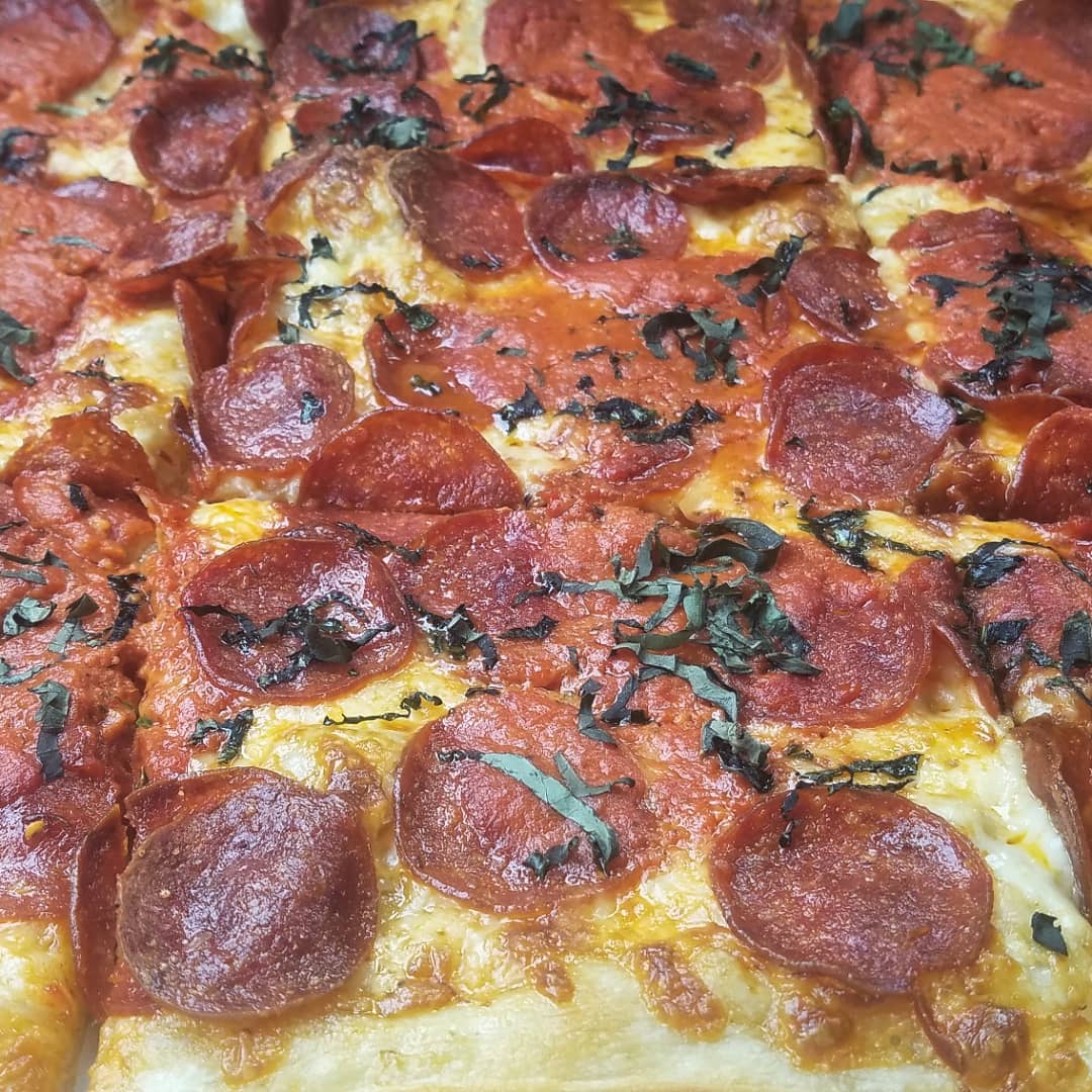 NOLA Pizza Co. has a process that has made them a popular addition to the local pizza scene. They have 10 pizza offerings on their menu. This is the #10: a square pie with vodka sauce, pepperoni and basil.