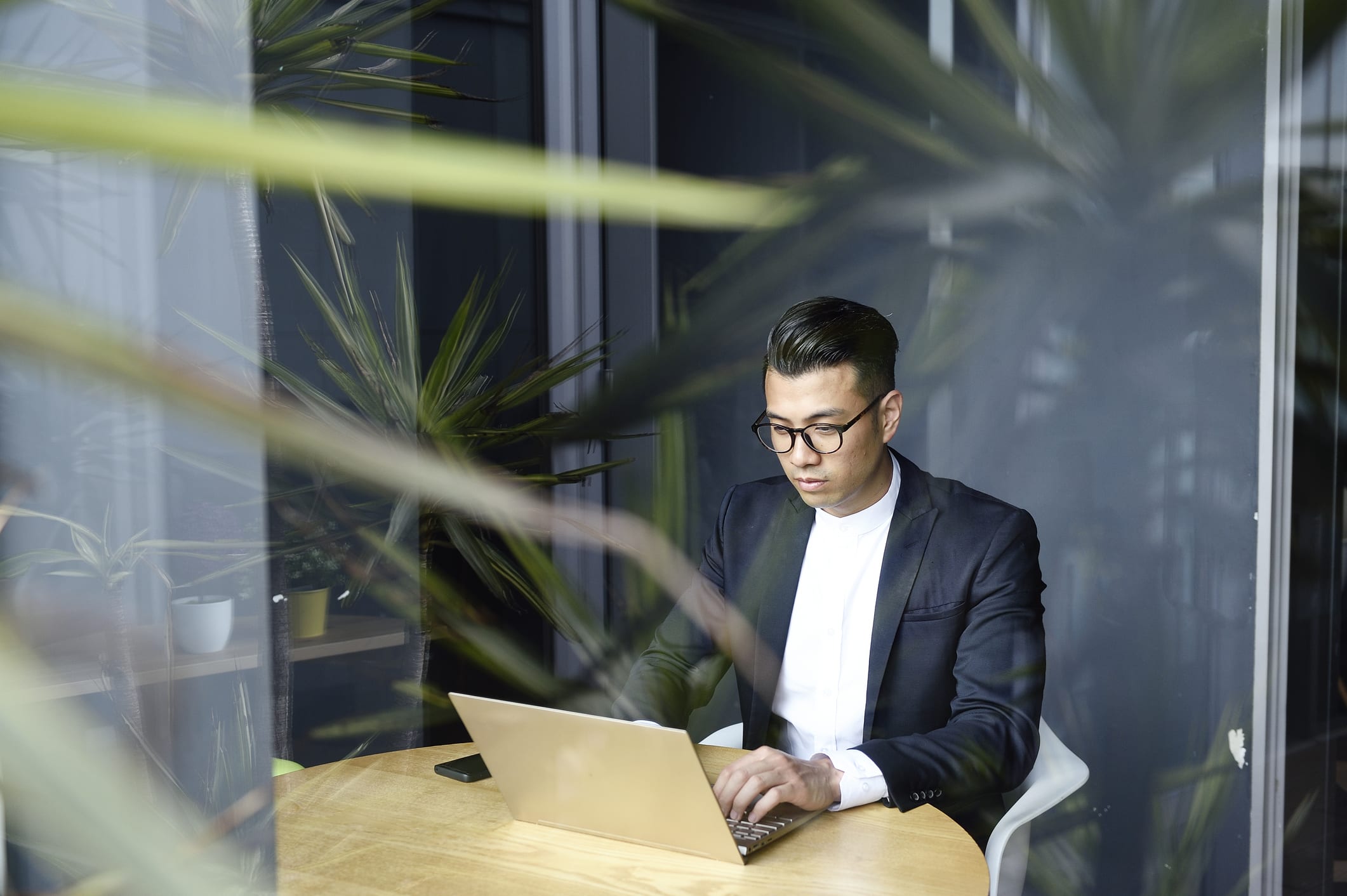 Handsome Asian man making online purchases with a credit card