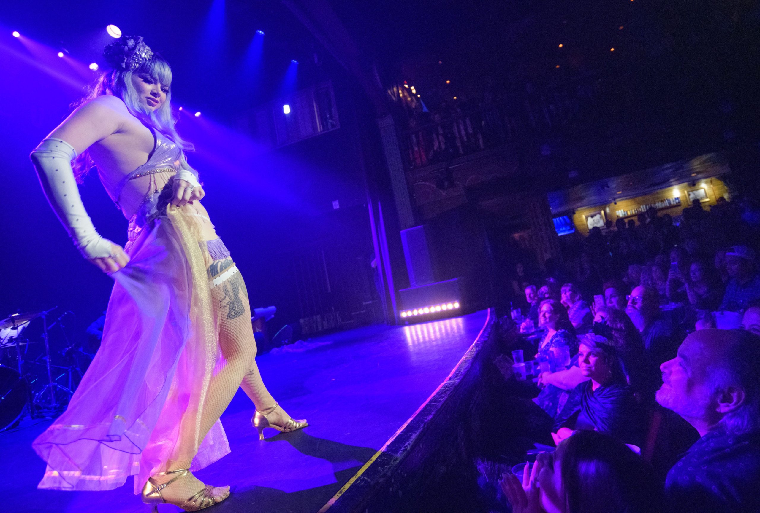 New Orleans resident and burlesque dancer Harper Hexx, which is her stage name, performs in the 2019 Queen of Burlesque competition during the 11th annual New Orleans Burlesque Festival at the House of Blues Saturday, September 14, 2019. The festival last three days with burlesque and other performers including escape artists, tap dancers, comedians and magicians. The main event invites burlesque dancers from around the world to perform to the music of a live jazz band and the chance to be crowned Queen at the end of the night. Hexx finished as the second runner-up to Albadoro Gala, a burlesque dancer from Italy. Hexx began as an exotic dancer on Bourbon Street at age 19 and said the first time she took her top off on stage she got a feeling of pure adrenaline. She has had her ups and downs since then dancing in the French Quarter. She is a recovering alcoholic and says one of her low points was falling down drunk. Now she uses mediation and yoga to help keep her mind clear. She recently joined Bustout Burlesque created by Rick Delaup, who also runs the festival, and has rededicated herself to learn more about the art and history of burlesque dancing including meeting Kitty West, also known as Evangeline the Oyster Girl, before she passed this year. Harper Hexx performs as least once a week and feels that dancing, like her mediations, keeps her centered. Other performers in the competition include dancers Queen Etouffante, Petit Cheire, Demi Dior, Sheila Shortcake, Lil Steph, and singer Naydja CoJoe. Photo by Matthew Hinton