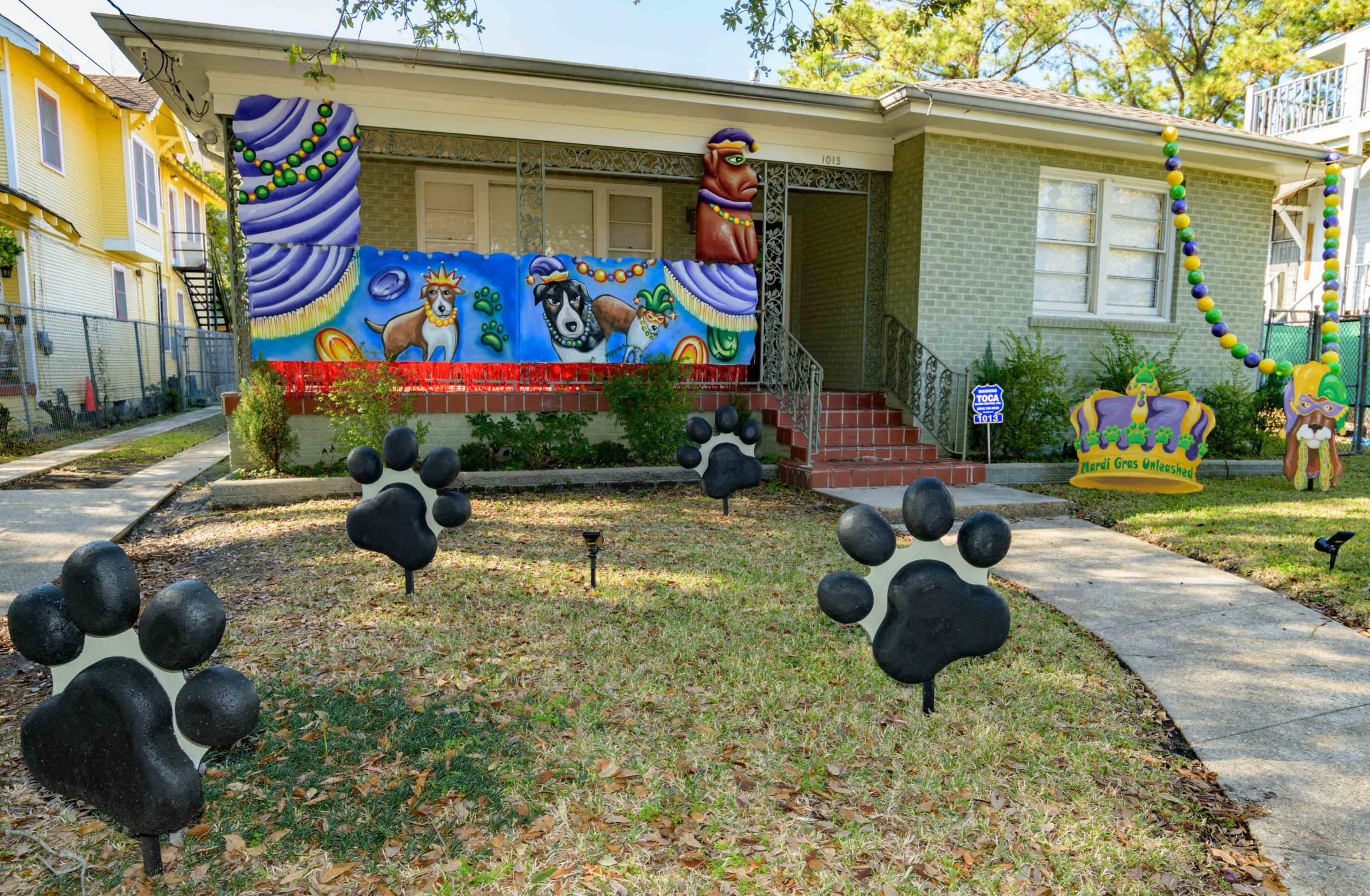 These puppies are free to a good home in front of a City Park neighborhood house decorated with the theme ÒMardi Gras Unleashed.Ó The home features a #PorchFloat created by Crescent City Artists, LLC. #CrescentCityArtists states that they are the first Black-owned Mardi Gras float service providers in Louisiana and are led by a New Orleans husband and wife duo ReneÊand InezÊPierre. The group has created several porch floats to fit on balconies and porches for the Krewe of House Floats, an initiative to decorate homes during the Carnival season because of the cancellation and postponement of parades and gatherings for #MardiGras2021 due to COVID-19 pandemic. Photos by @MattHintonPhoto for @VeryLocalNOLA
@rene.pierre.315213Ê#neworleansÊ#louisianaÊ#mardigrasÊ#nolaÊ#504 #blackownedbusiness #vlnolamardigras #Carnival #neworleanslouisiana #nolalife #herenowlouisiana #gonola #onetimeinnola #itsyournola #showmeyournola #nola #followyournola #exploreneworleans #ilovenola #VLNOLA #kreweofhousefloatsÊ#mardigras2021 @kreweofhousefloats #MardiGrasUnleashed #MardiGrasthrows #puppies #MardiGrasbeads #housefloat