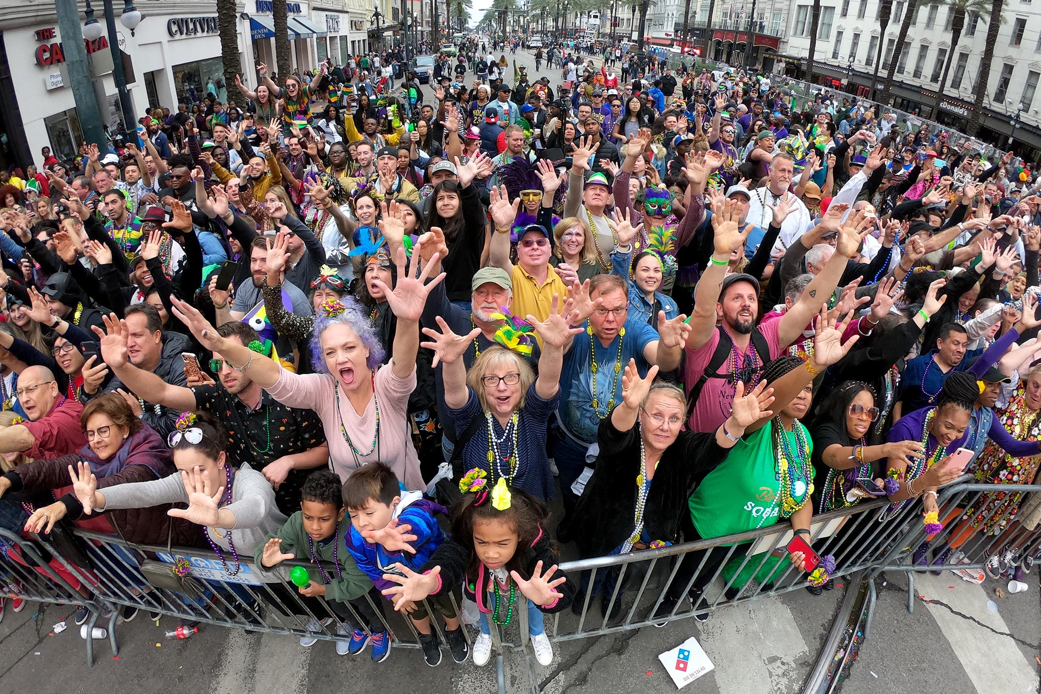 The crowd catches throws on Canal Street as the 440 riders of Rex, King of Carnival, roll down the Uptown route on 26 floats with their 139th parade entitled “Omens and Auguries” on Mardi Gras Day, 2020. (Photo by Michael DeMocker)