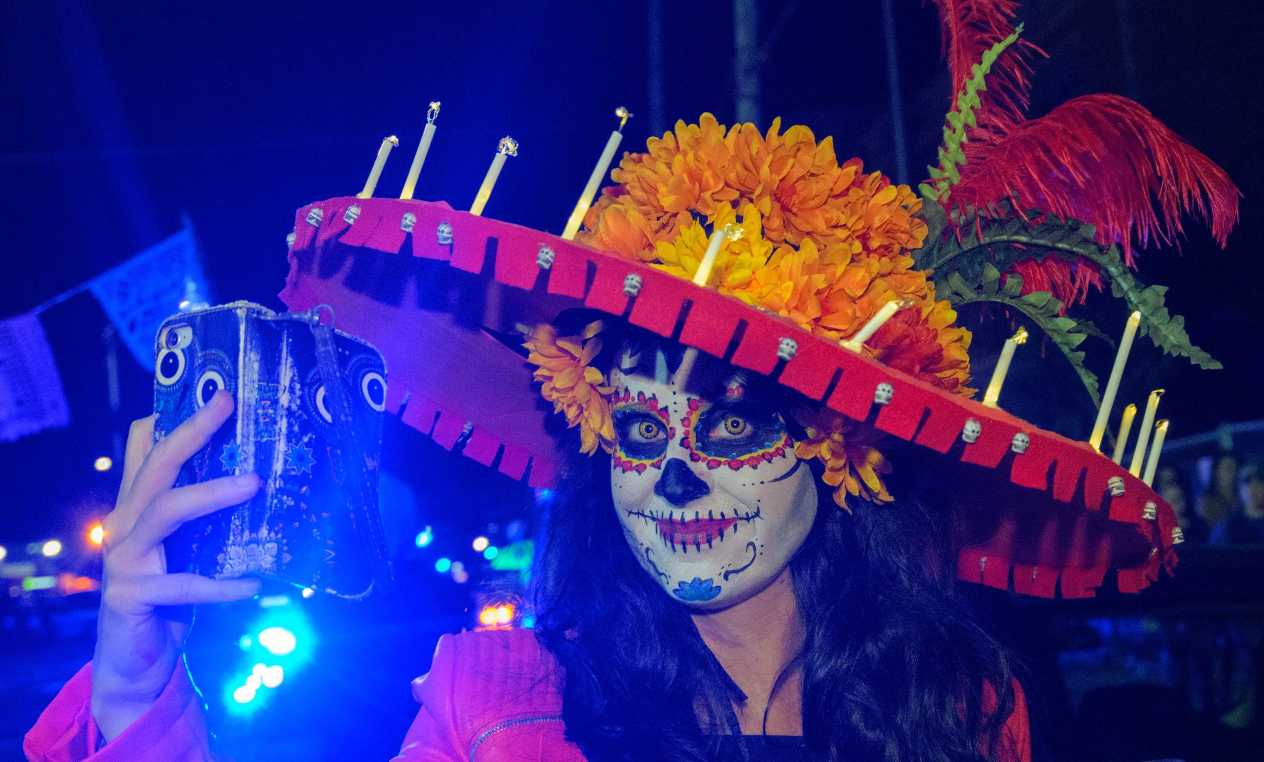 Krewe de Mayahuel parades in the St. Roch neighborhood from Carnaval Lounge to St. Roch Cemetery as part of a Day of the Dead procession to remember and celebrate loved ones who have passed in New Orleans, Louisiana Saturday, November 2, 2019. Mayahuel is named after the Aztec goddess of agave, the plant used to make tequila. The group was founded by Mexican immigrants including Roberto Carrillo, a native of Mexico City who moved to New Orleans along with other Mexican immigrant construction workers after Hurricane Katrina. Drum groups including Skinz N Bonez and Bloco Jacaré, a Brazilian group from Baton Rouge which means alligator in Portuguese, accompanied the krewe. Photo by Matthew Hinton