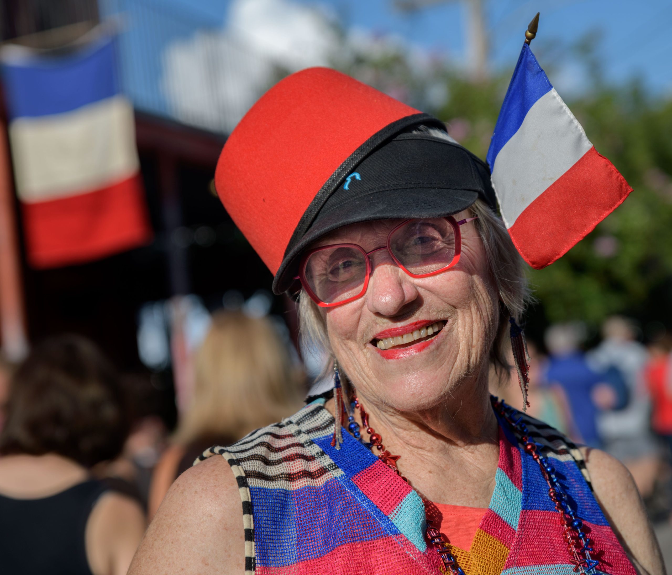 Nancy Ochsenschlager shows her support for France as she walks down Ponce de Leon Street for the 13th Annual Faubourg St. John Bastille Day Block Party in New Orleans, La. Saturday, July 27, 2019. Originally scheduled for Bastille Day, July 14, 2019, the event was moved because of the approach of Hurricane Barry.  The event is put on by local merchants including Pal's Lounge, Cafe Degas, 1000 Figs, Catty Shack, the Faubourg St. John Neighborhood Association, the French American Chamber of Commerce Gulf Coast Chapter, Liuzzas by the Track, Nonna Mia, Lolas, Santa Fe, Swirl Wines and Toast Cafe. Bastille Day celebrates the French National Day and the storming of the Bastille fortress and political prison on July 14, 1789. Photo by Matthew Hinton