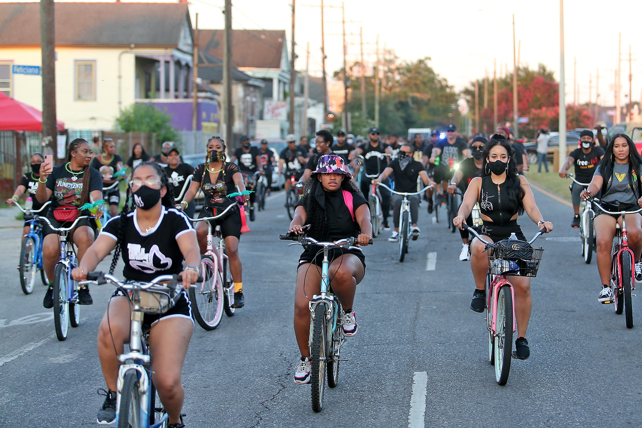 Riders make their way down St. Claude Avenue during the Juneteenth Blackout Bike Ride which began in the 3100 block of St. Claude Avenue and made pit-stops at several Black-owned businesses. The ride was one of several local and national events marking Juneteenth, the day in 1865 when slaves in Galveston, Texas finally learned they had been freed. Photographed on Friday, June 19, 2020. (Photo by Michael DeMocker)