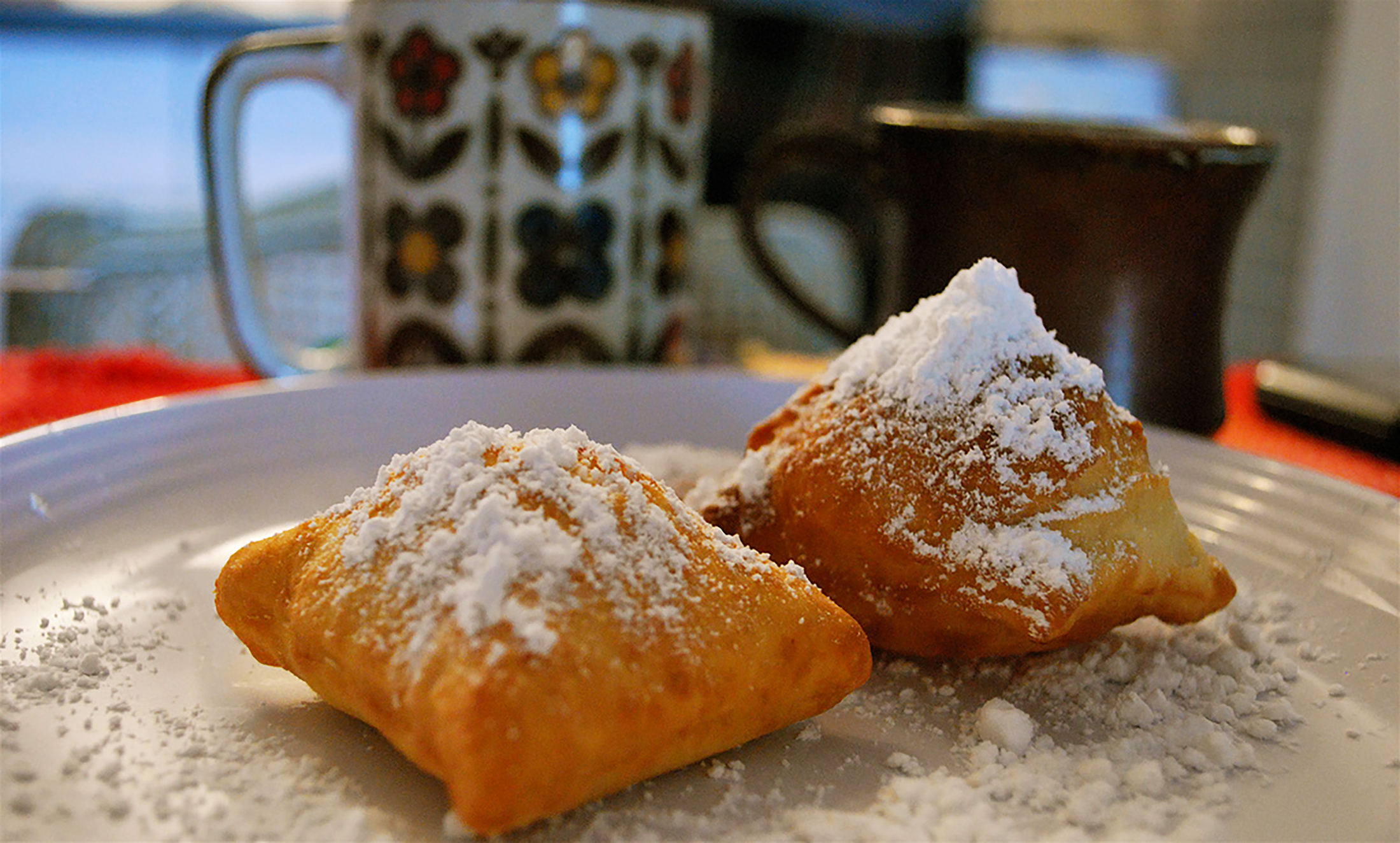 Cafe du Monde beignets and coffee. Photo was shared on Flickr Creative Commons by Valerie Hinojosa.