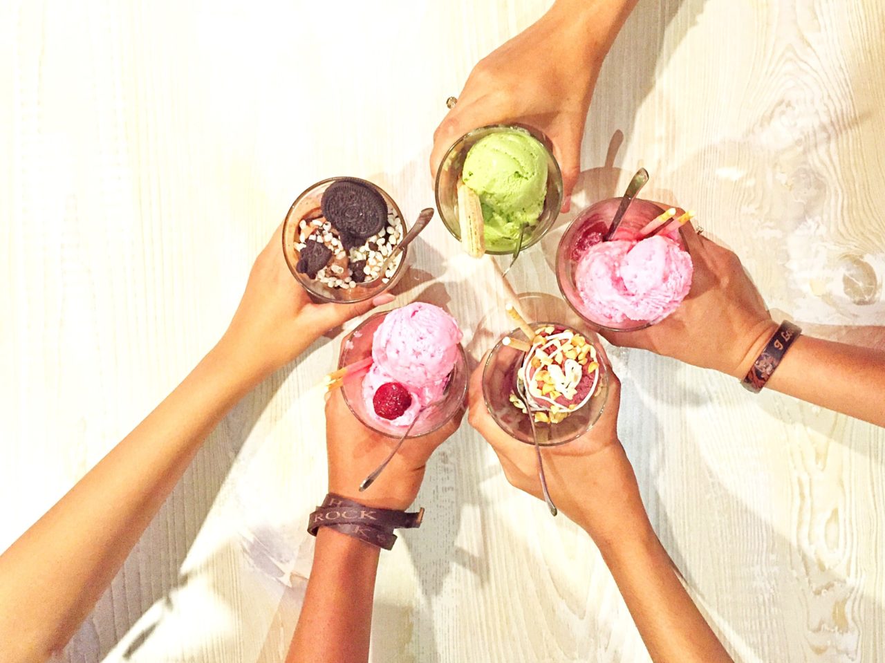 High Angle View Of Friends Cheering Ice Creams