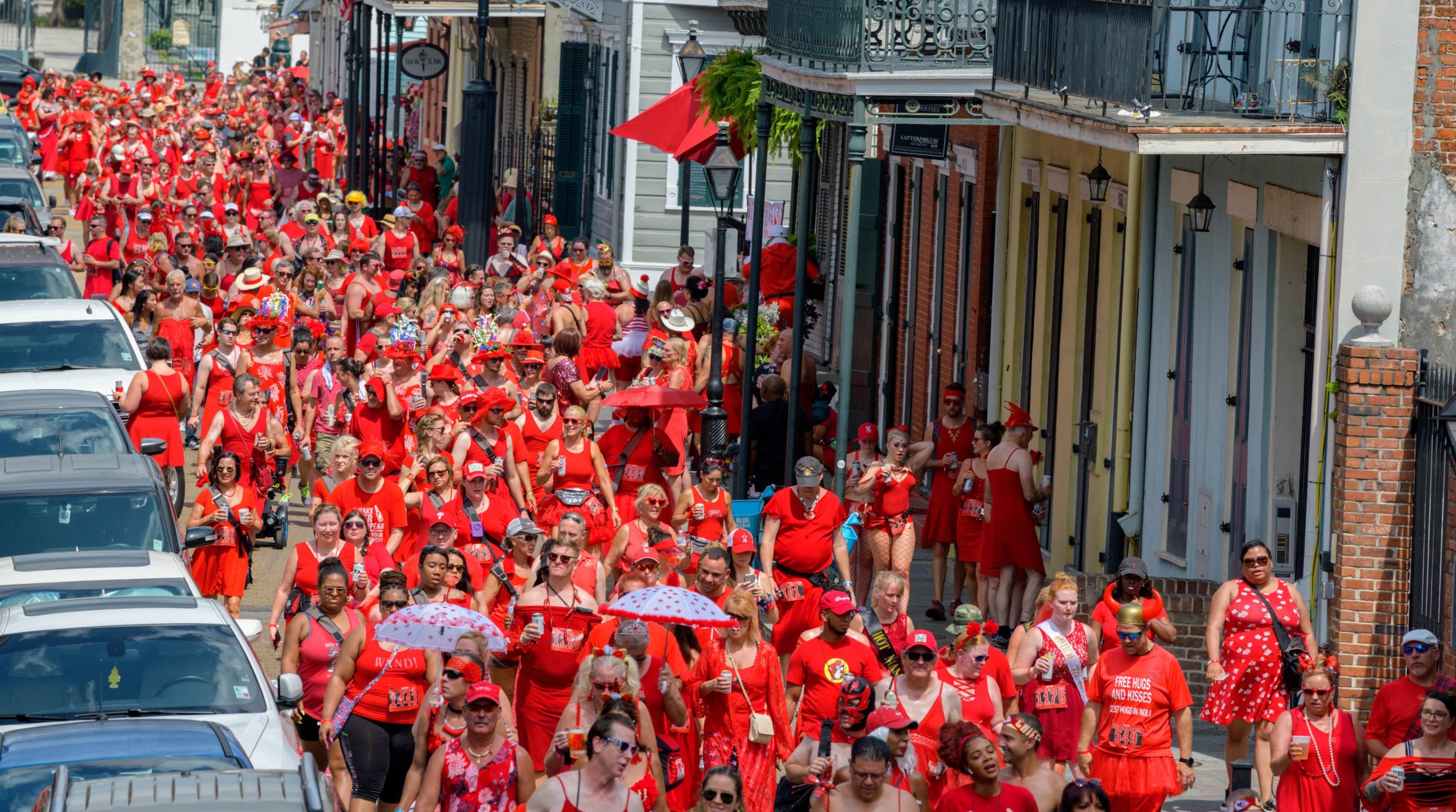 Runners take part 25th annual New Orleans Red Dress Run that is put on by the Hash House Harriers who call their group A Drinking Club with a Running Problem in New Orleans, La. Saturday, Aug. 10, 2019. The annual event also raises money for charities awarding over $1 million in grants over the years. Most people dont run and instead hang out in the French Quarter. Photo by Matthew Hinton