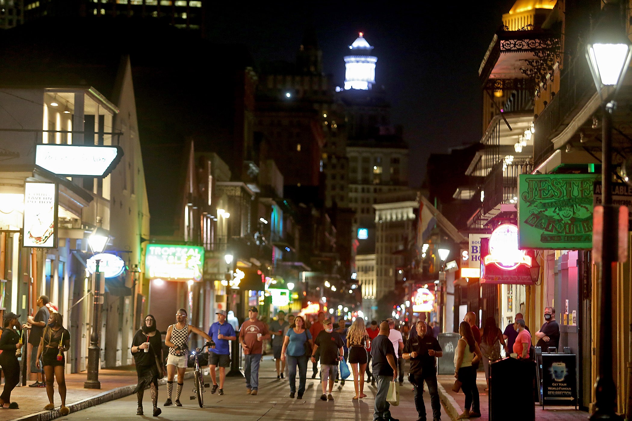 People stroll in the 600 block of Bourbon Street as Phase Two allows for 50% capacity at restaurants and the limited re-opening of bars in New Orleans on Saturday, June 13, 2020. (Photo by Michael DeMocker)