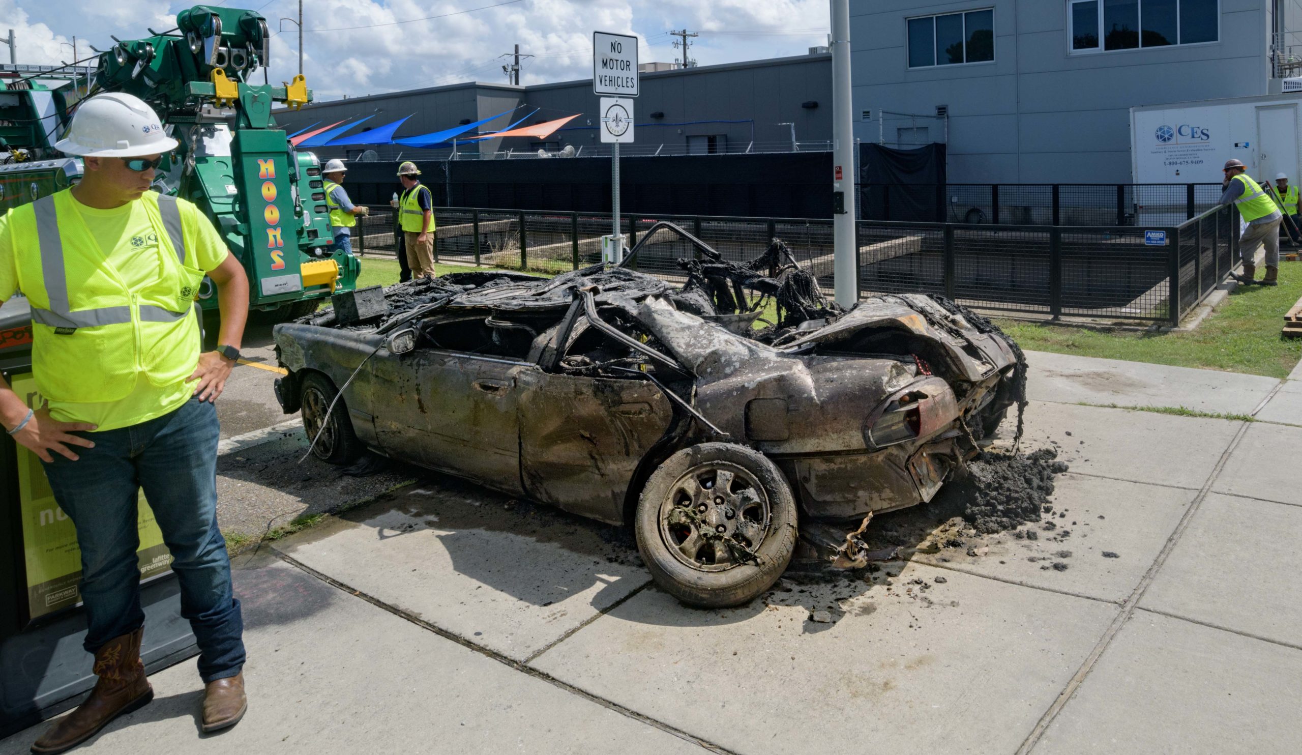 A Mazada 626 car with a 2007 Louisiana brake tag and Mardi Gras beads coming from the trunk is removed from deep inside the Lafitte Canal that drains flood and other water from Mid-City including the Lafitte Greenway in New Orleans, La. Thursday, Aug. 22, 2019. It is among the largest pieces to pulled from a New Orleans drainage canal by the Sewerage and Water Board. The city has suffered a few 100-year flooding events which have been exacerbated by poor drainage in the canals, pumping problems, and clogged catch basins.  Photo by Matthew Hinton