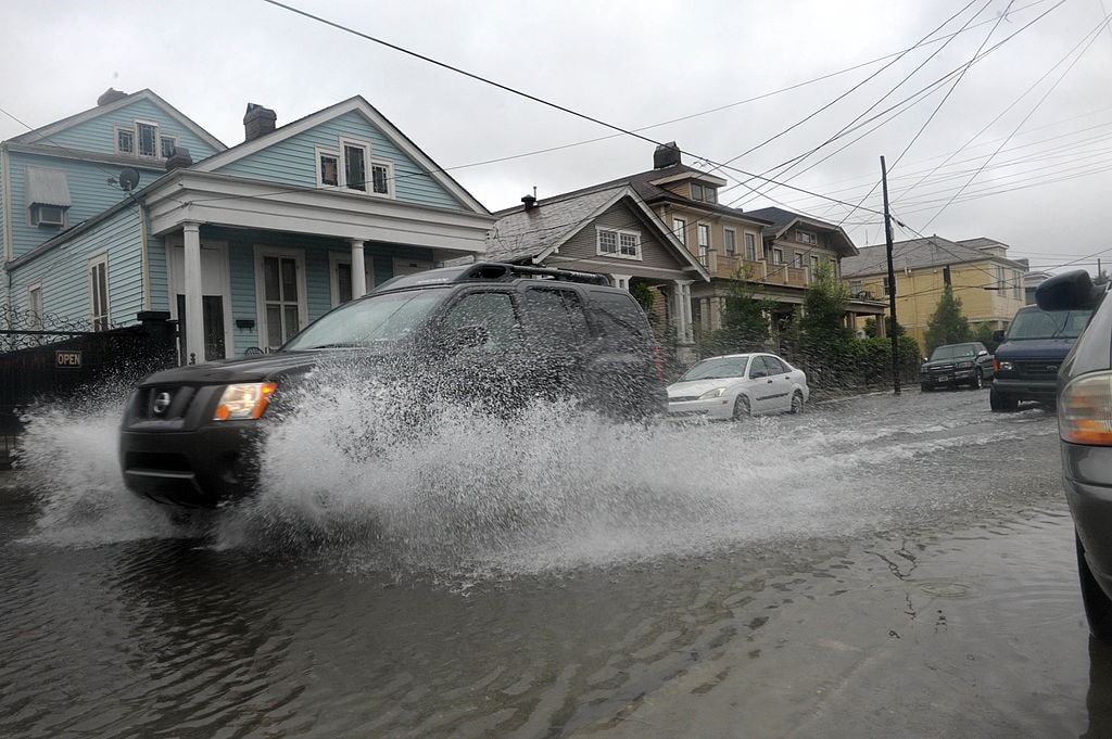 NEW ORLEANS, LA - SEPTEMBER 3: A car passes through minor street flooding in an uptown neighborhood following heavy rains from Tropical Storm Lee hit the area September 3, 2011 in New Orleans, Louisiana. The U.S. National Hurricane Center (NHC) warned of heavy rain across southeastern and south-central Louisiana and forcasted that the storm would continue its slow, potentially erratic motion toward the north or northwest over the next day.   (Photo by Cheryl Gerber/Getty Images)