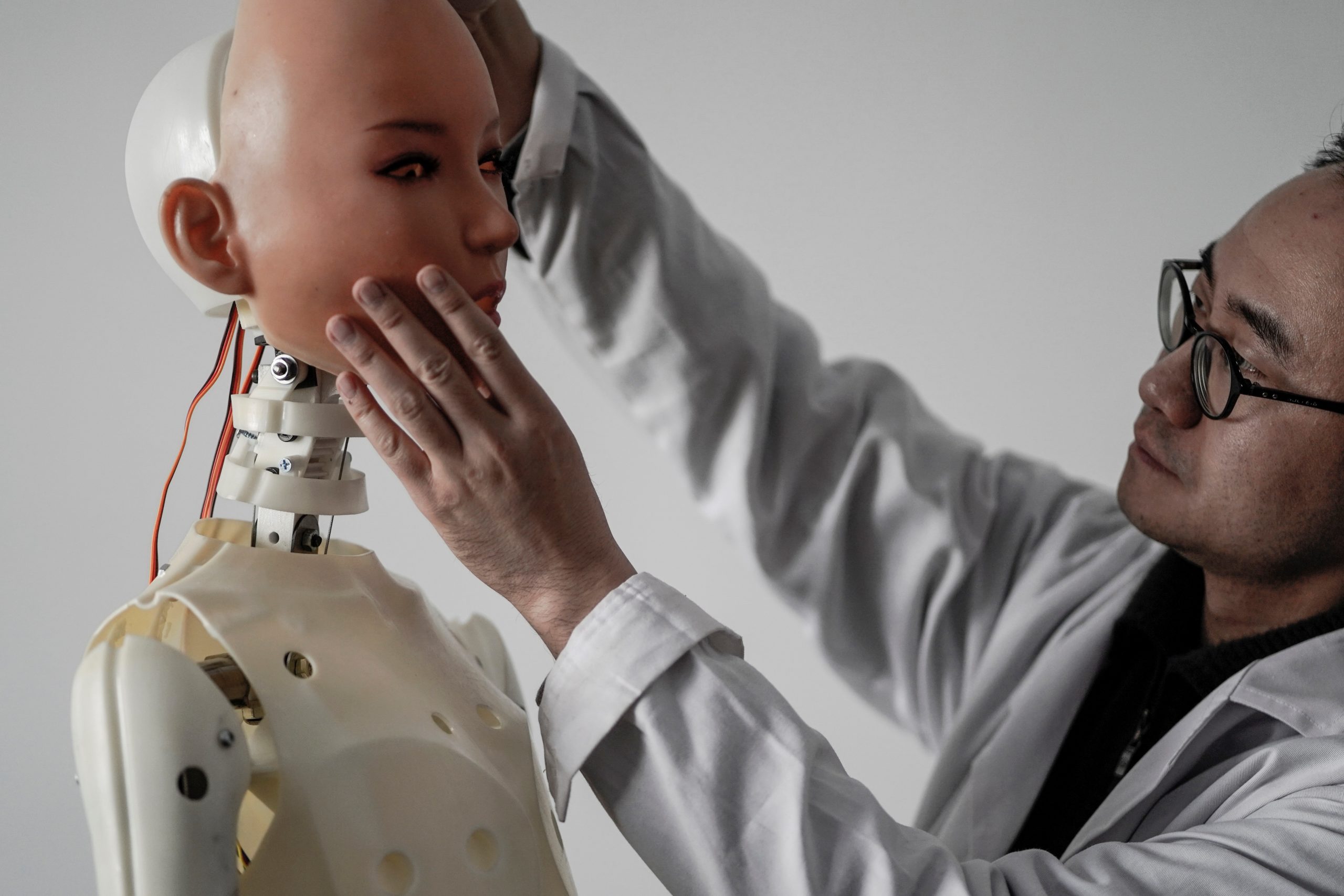 This photo taken on February 1, 2018 shows an engineer holding a silicon face against the head of a robot at a lab of a doll factory of EXDOLL, a firm based in the northeastern Chinese port city of Dalian.
With China facing a massive gender gap and a greying population, a company wants to hook up lonely men and retirees with a new kind of companion: "Smart" sex dolls that can talk, play music and turn on dishwashers. / AFP PHOTO / FRED DUFOUR / TO GO WITH China-sex-lifestyle, FOCUS by Joanna CHIU        (Photo credit should read FRED DUFOUR/AFP/Getty Images)