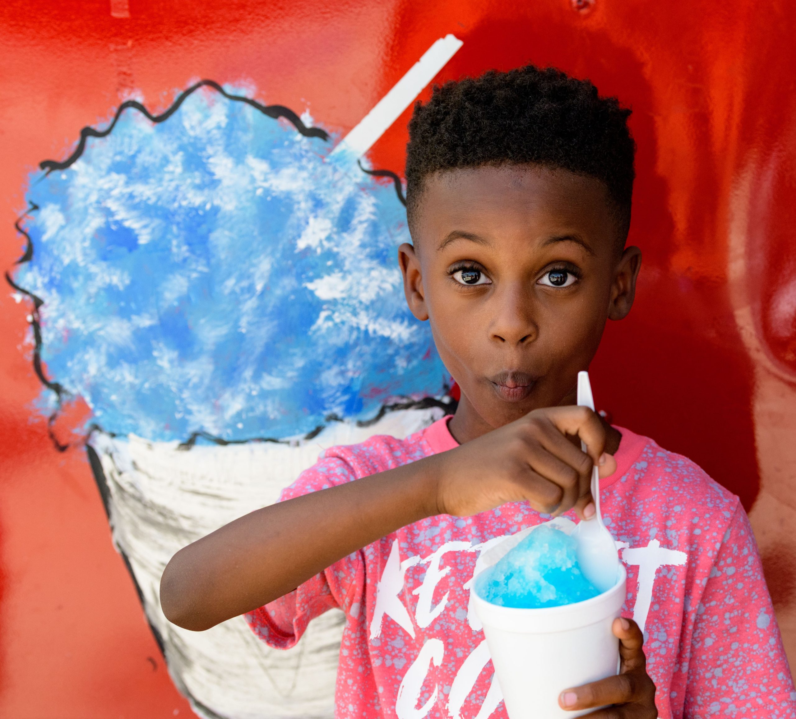 Jalen Gordon enjoys a snoball from Danielle's New Orleans Style Sno Balls  during the SneauxBall Festival in New Orleans East on Thursday, the 4th of July. The event featured live entertainment, family fun activities and celebration of the opening the Miracle Plaza by Jesseca Dupart to serve the New Orleans East community in the 5900 block of Bullard Avenue. Festival goers had a chance to enjoy a wide variety of sneauxballs including designer sneauxballs from Sweet Thangs by NOLA Sips. As well as a dance competition won by iNfinity Competitive Cheerleading &amp; Dance Co and a car show sponsored by Hott Rodd Productions. The event was presented by District E city council member Cyndi Nguyen. Photo by Matthew Hinton