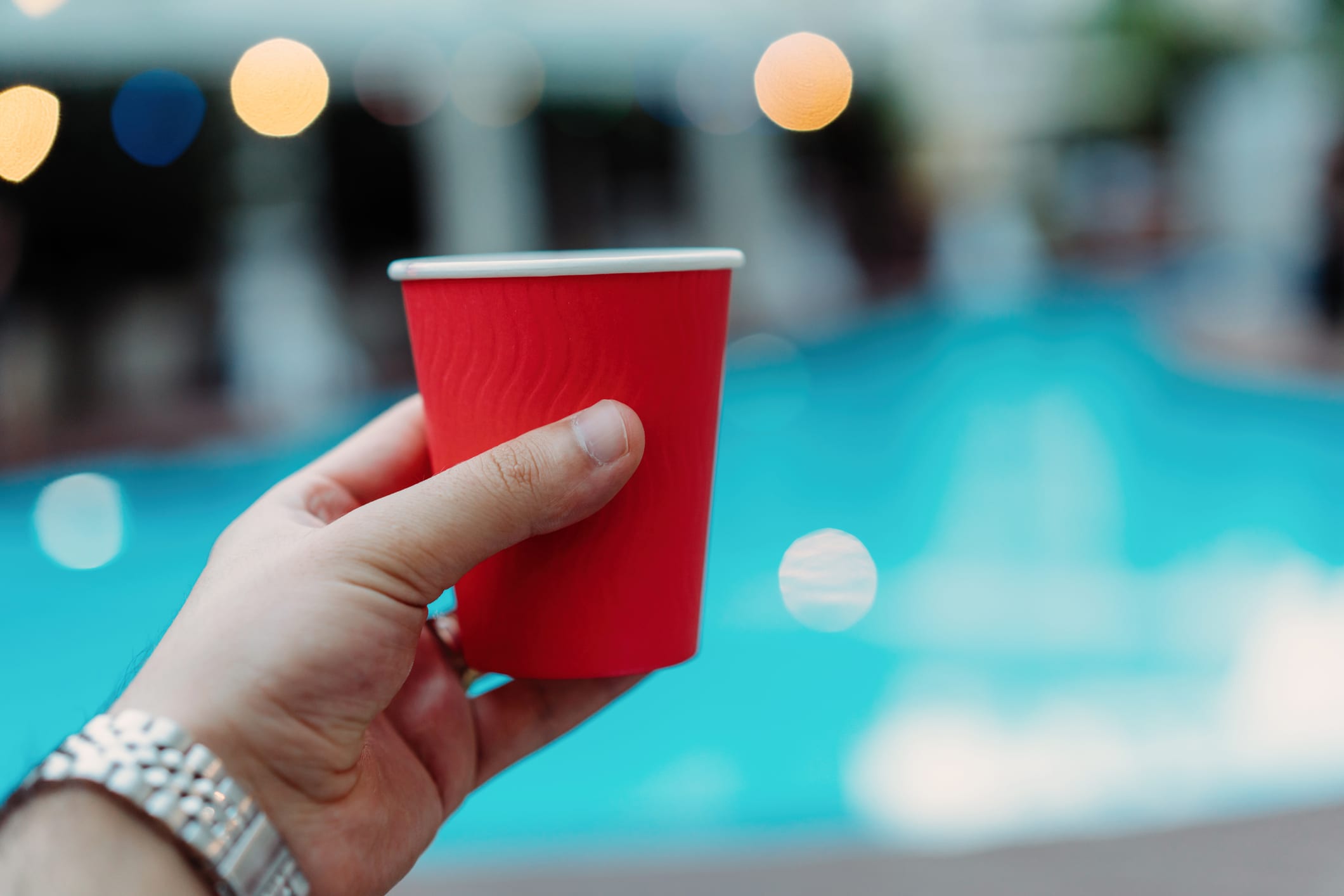 Young man holding red party cup