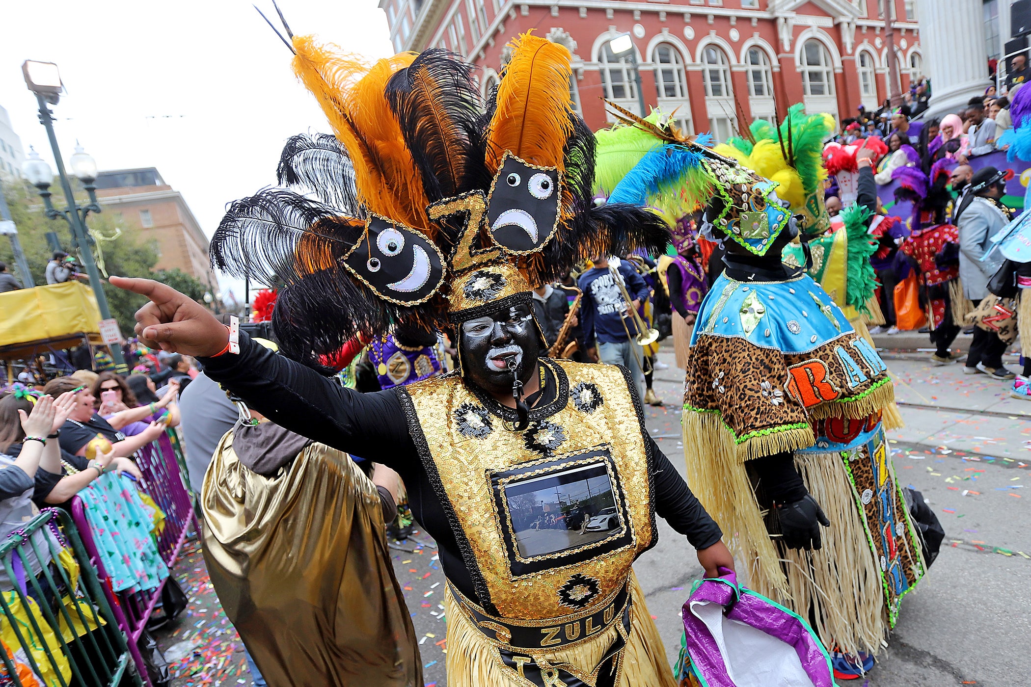 A marching group passes Gallier Hall as the 1,500 members of the Zulu, led by their King Brian M. Sims and Queen Dr. Chanda Macias, roll up St. Charles Avenue with their parade entitled “Zulu’s Book of Love and Cinema” on Mardi Gras Day, 2020. (Photo by Michael DeMocker)