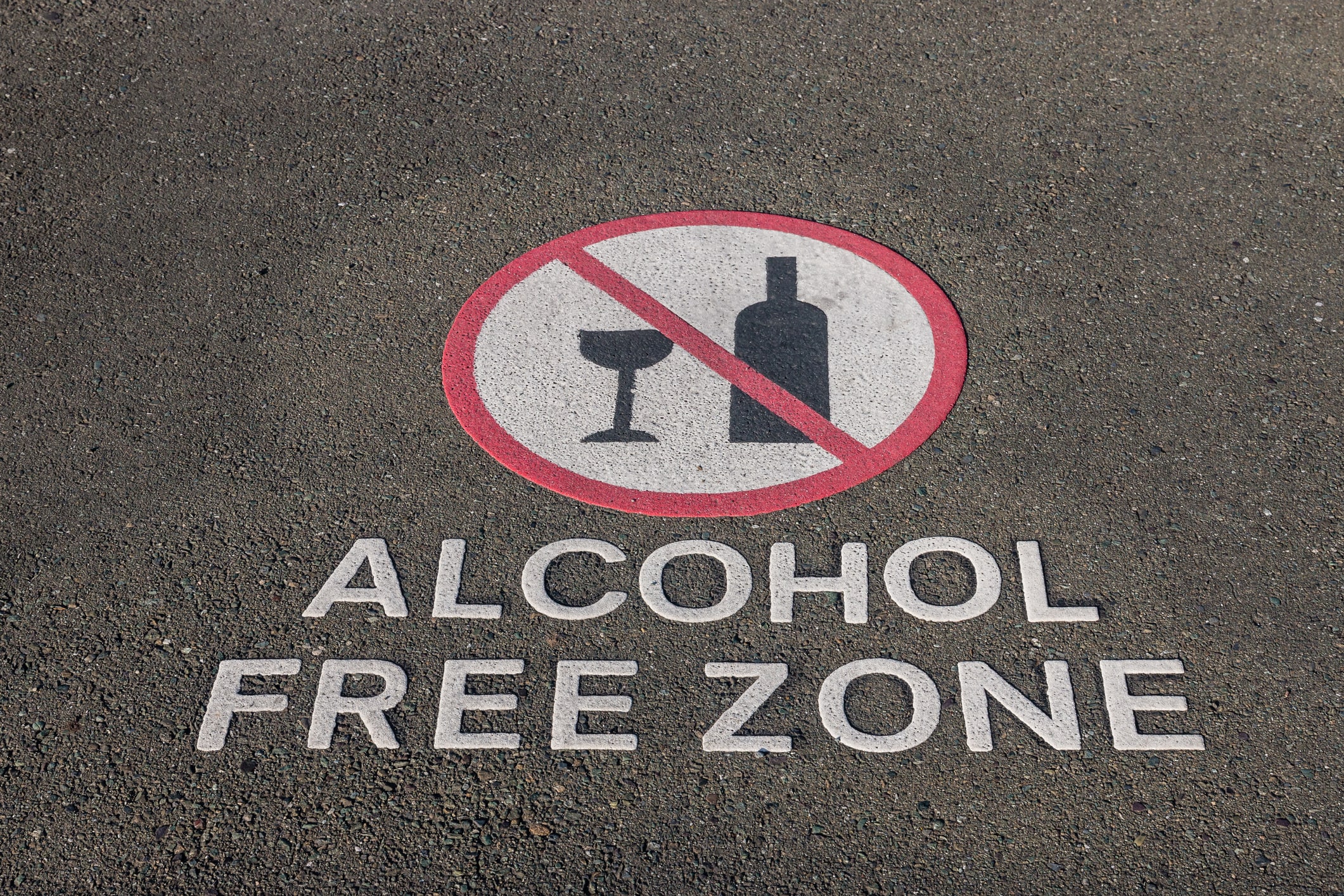 closeup of alcohol free zone sign on pavement