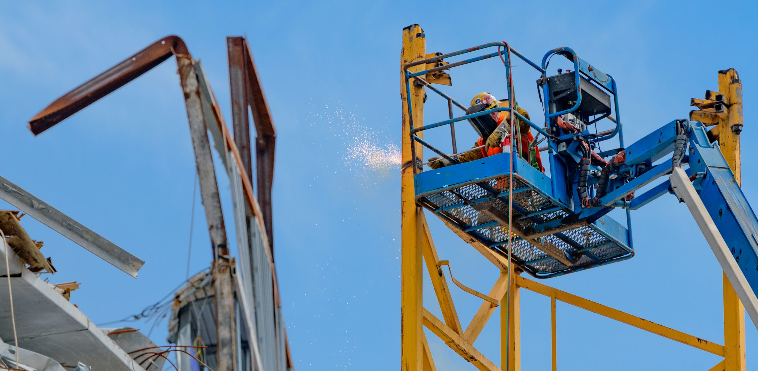 A welder removes a piece of one of the cranes in preparation of the demolition of the main Hard Rock Hotel collapse site in New Orleans, La. Tuesday, May 26, 2020. The crane was impaled into N. Rampart Street after the two cranes were dynamited last year. The cranes were leaning and would have liked fallen on their own if not dynamited / imploded. Workers Anthony Bubba Magrette, Jose Ponce Arreola, and Quinnyon Q Wimberly, lost their lives in the partial collapse of the Hard Rock Hotel construction site on October 12, 2019. The bodies of Arreola and Wimberly have yet to be recovered from the collapse site. Photo by Matthew Hinton