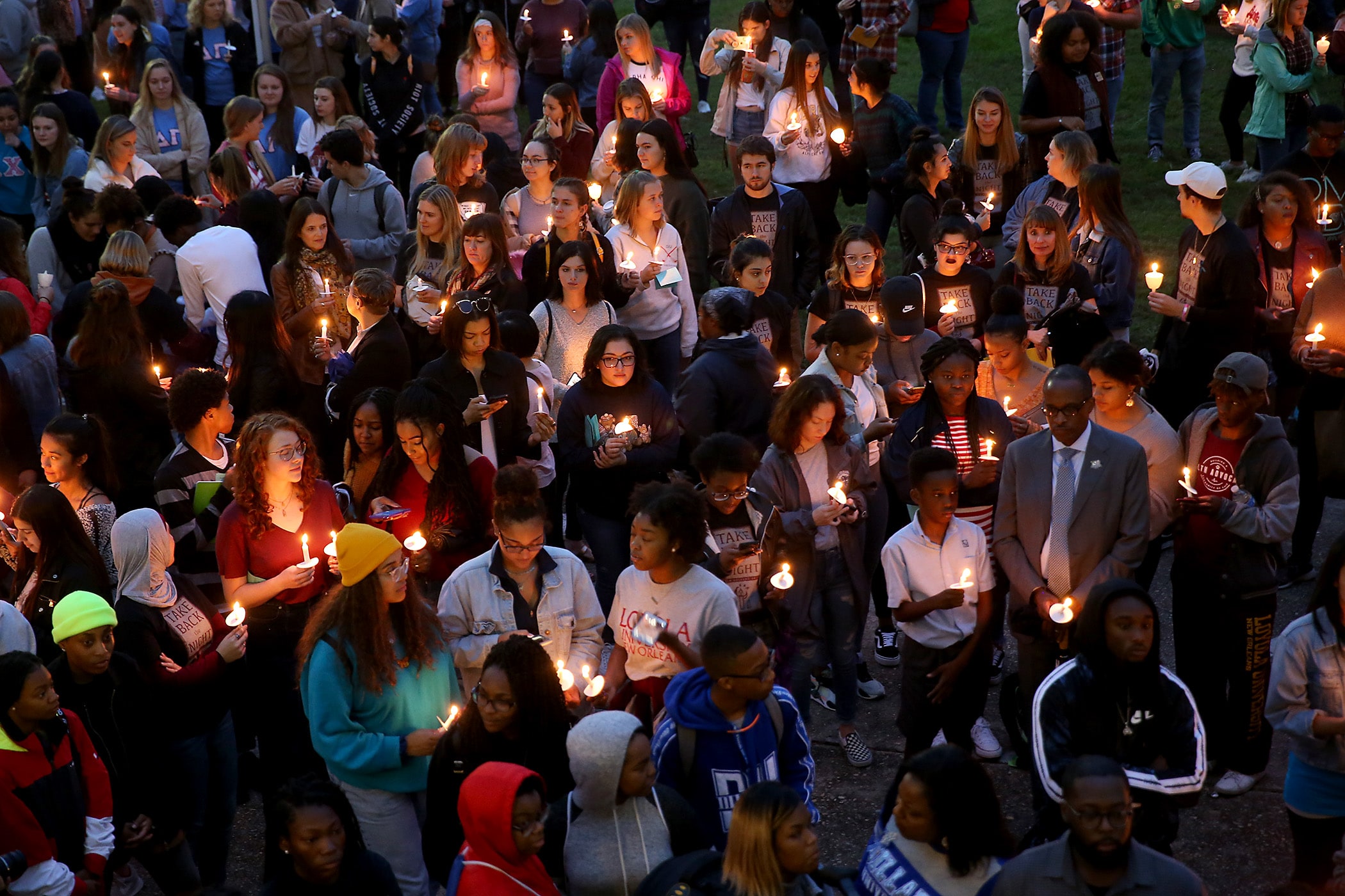 Hundreds of students, faculty members and staff from Tulane, Loyola, SUNO, Xavier, Dillard and UNO hold candles as they gather in the horseshoe at Loyola University for the 28th annual Take Back the Night Candlelight Vigil and March Against Sexual Violence on Thursday, October 24, 2019. (Photo by Michael DeMocker)
